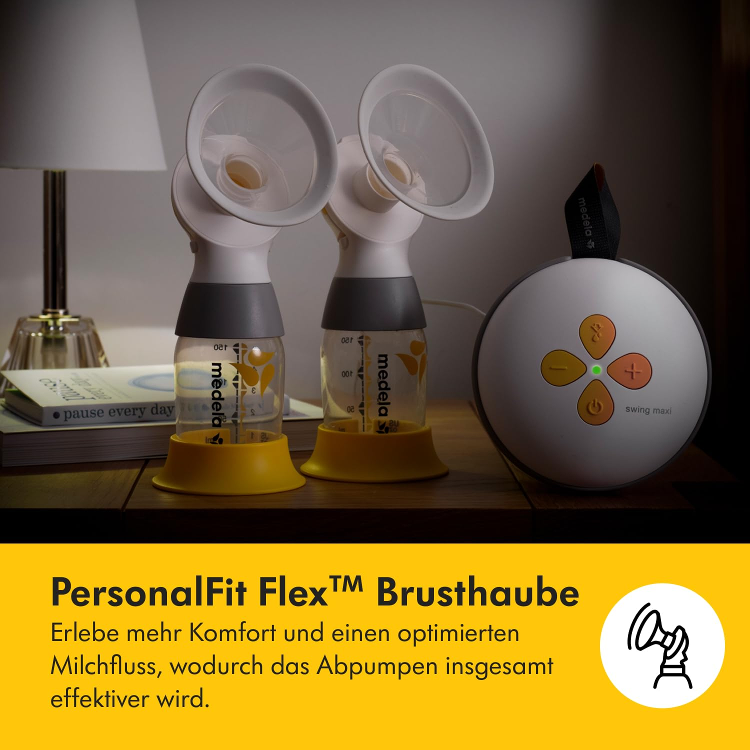 Brustpumpe mit zwei Trichtern, einer Steuereinheit und einem Buch auf einem Holztisch. Die Pumpe ist weiß und gelb.