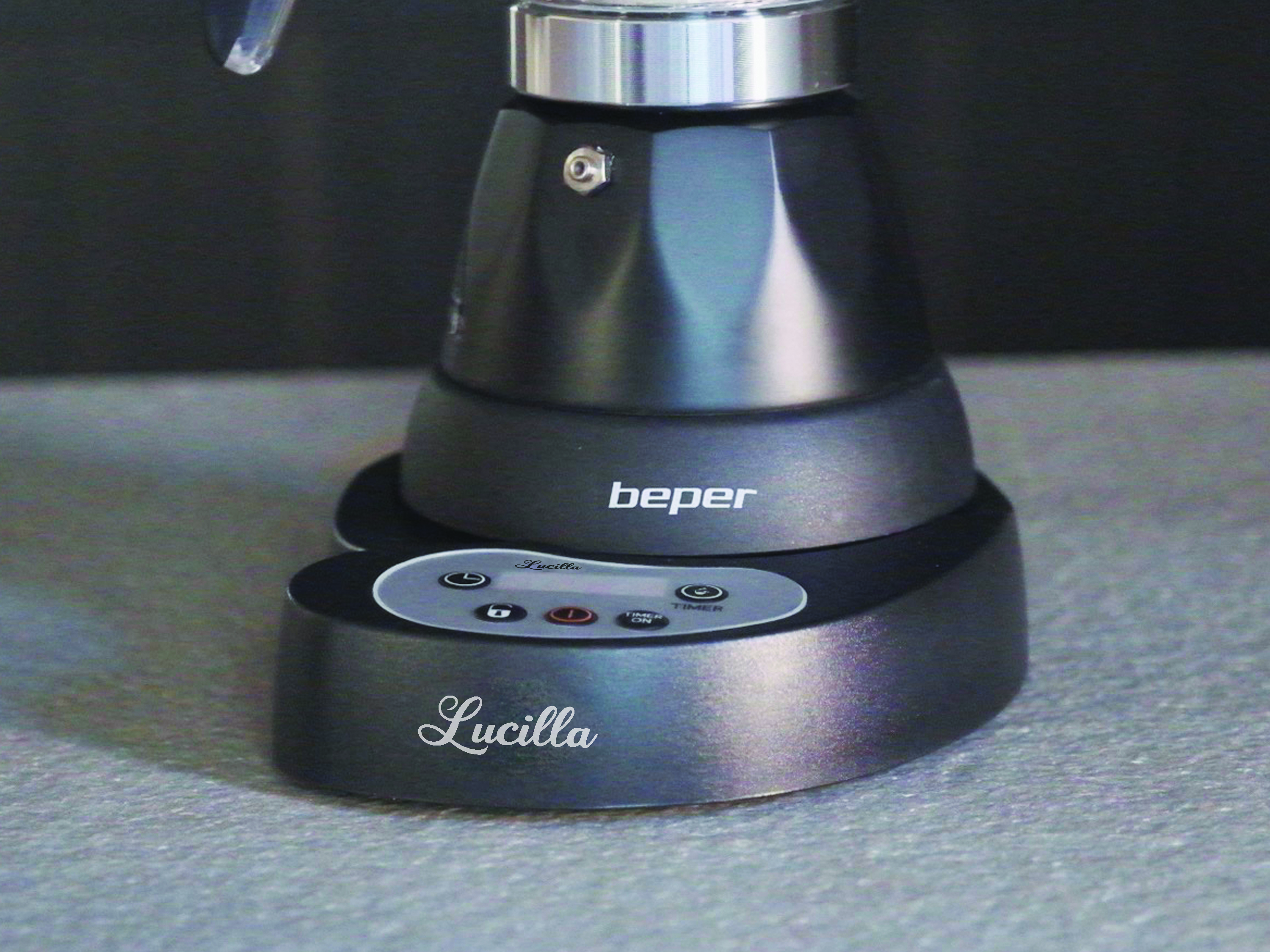 Una macchina per caffè espresso Lucilla grigio scuro su una superficie grigia. Il marchio Beper è visibile. Pulsanti e timer sulla base.