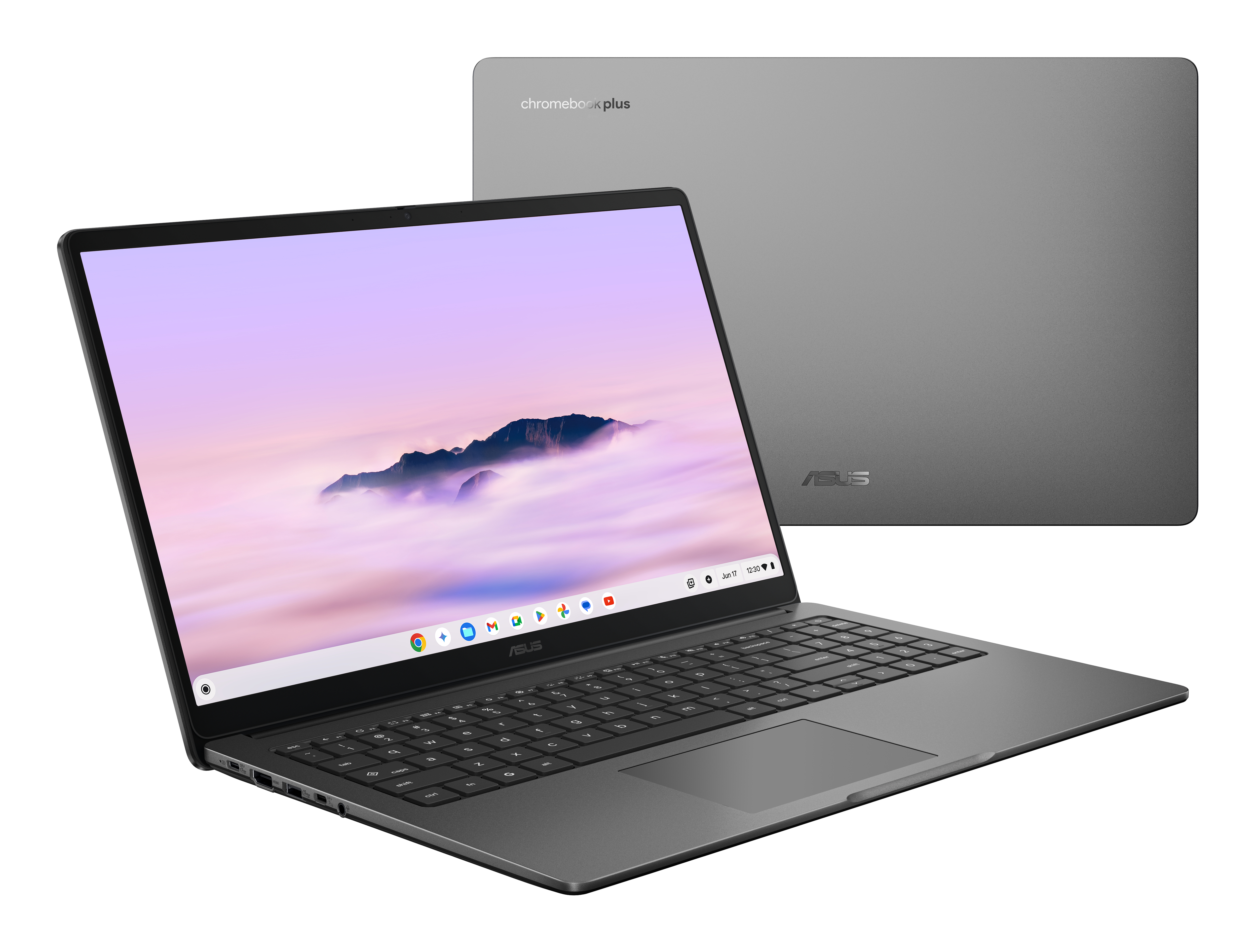 Szary laptop Asus Chromebook Plus jest otwarty, pokazując scenę górską na ekranie, drugi laptop w tle.