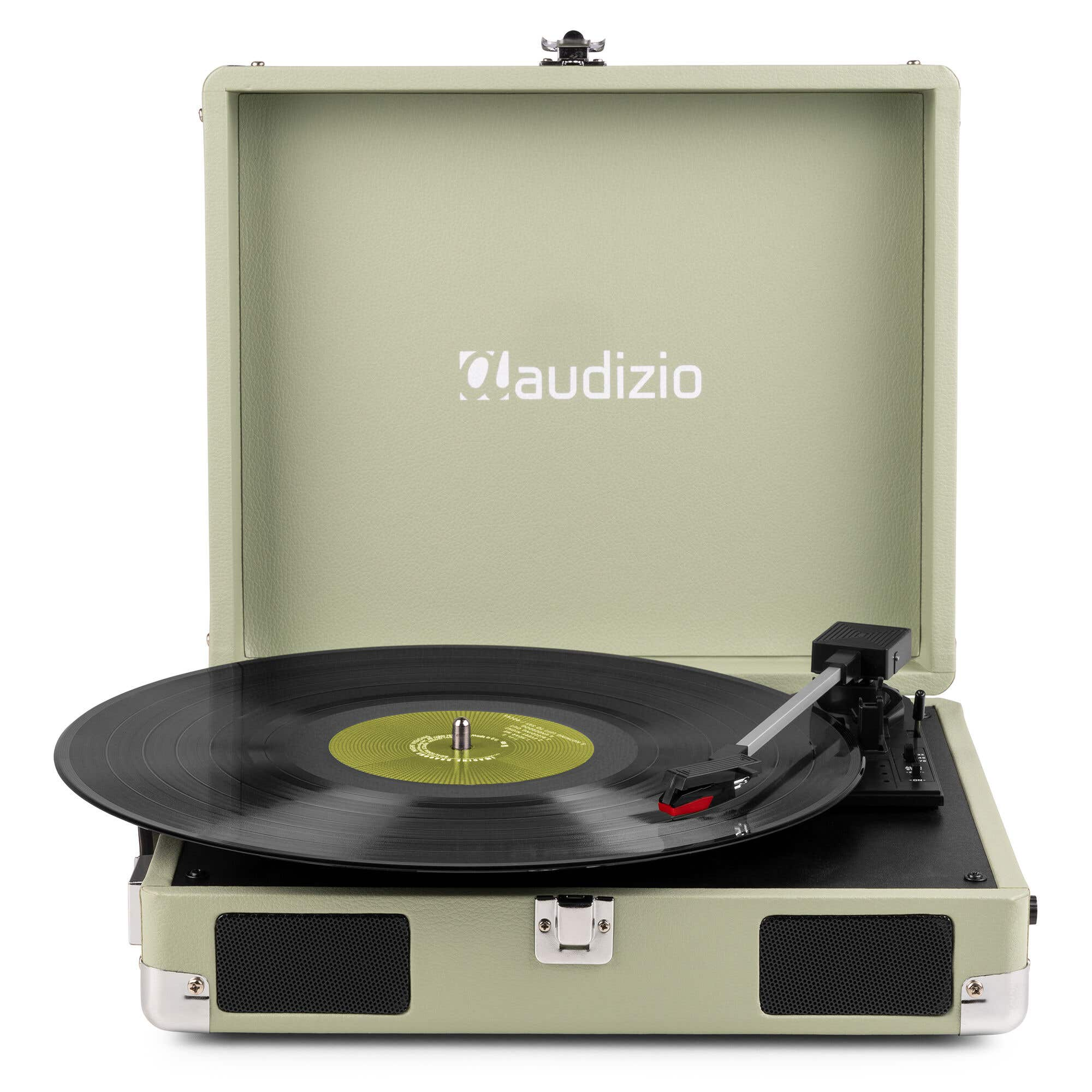 A sage green record player with a black vinyl record. The lid is open, showing the audizio logo.