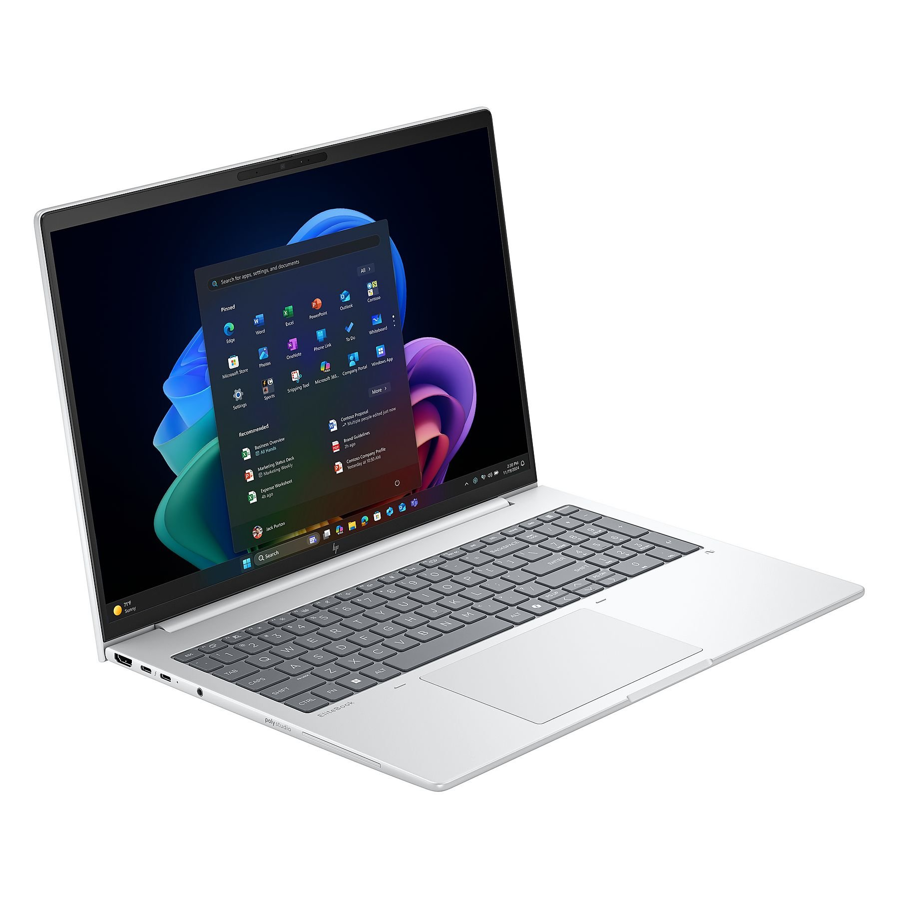 Un laptop argentato mostra l'interfaccia di Windows 11. Lo schermo mostra app e icone. La tastiera è visibile.
