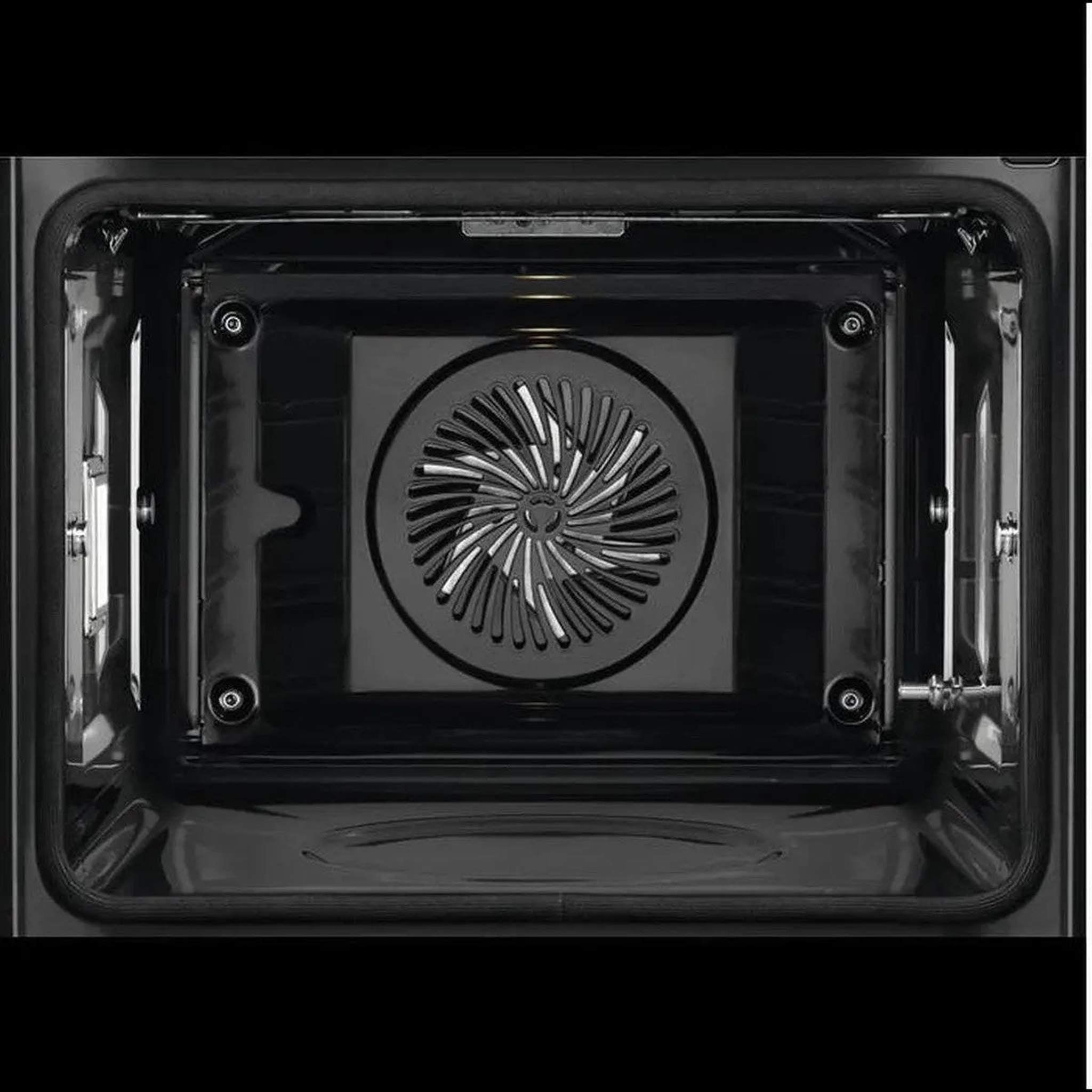 À l'intérieur d'un four noir. Un ventilateur est visible au centre, entouré des parois du four et d'un cadre sombre.