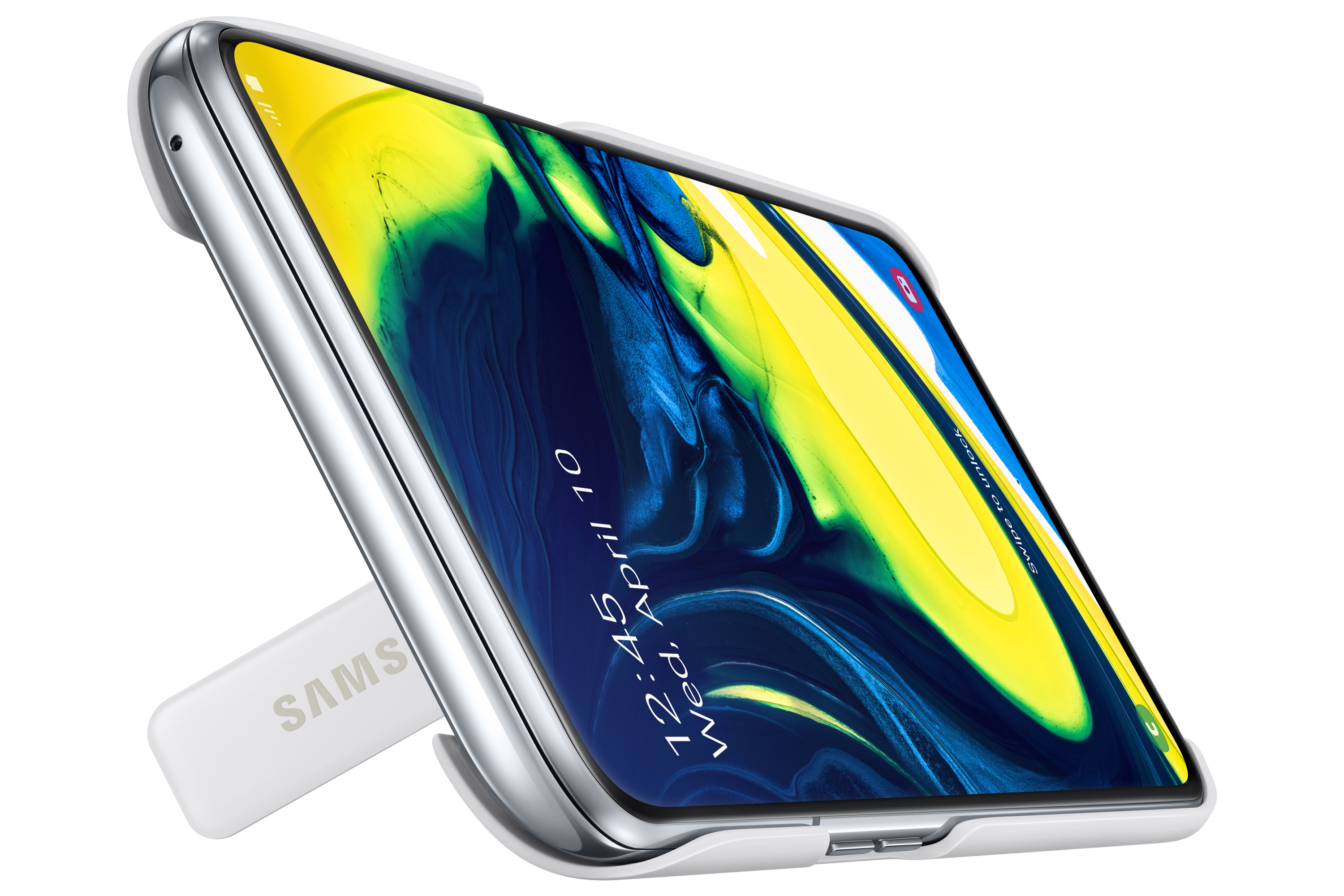 Un telefono argentato su un supporto bianco. Lo schermo mostra un'immagine astratta colorata con la data. Il supporto ha 'SAMSUNG'.