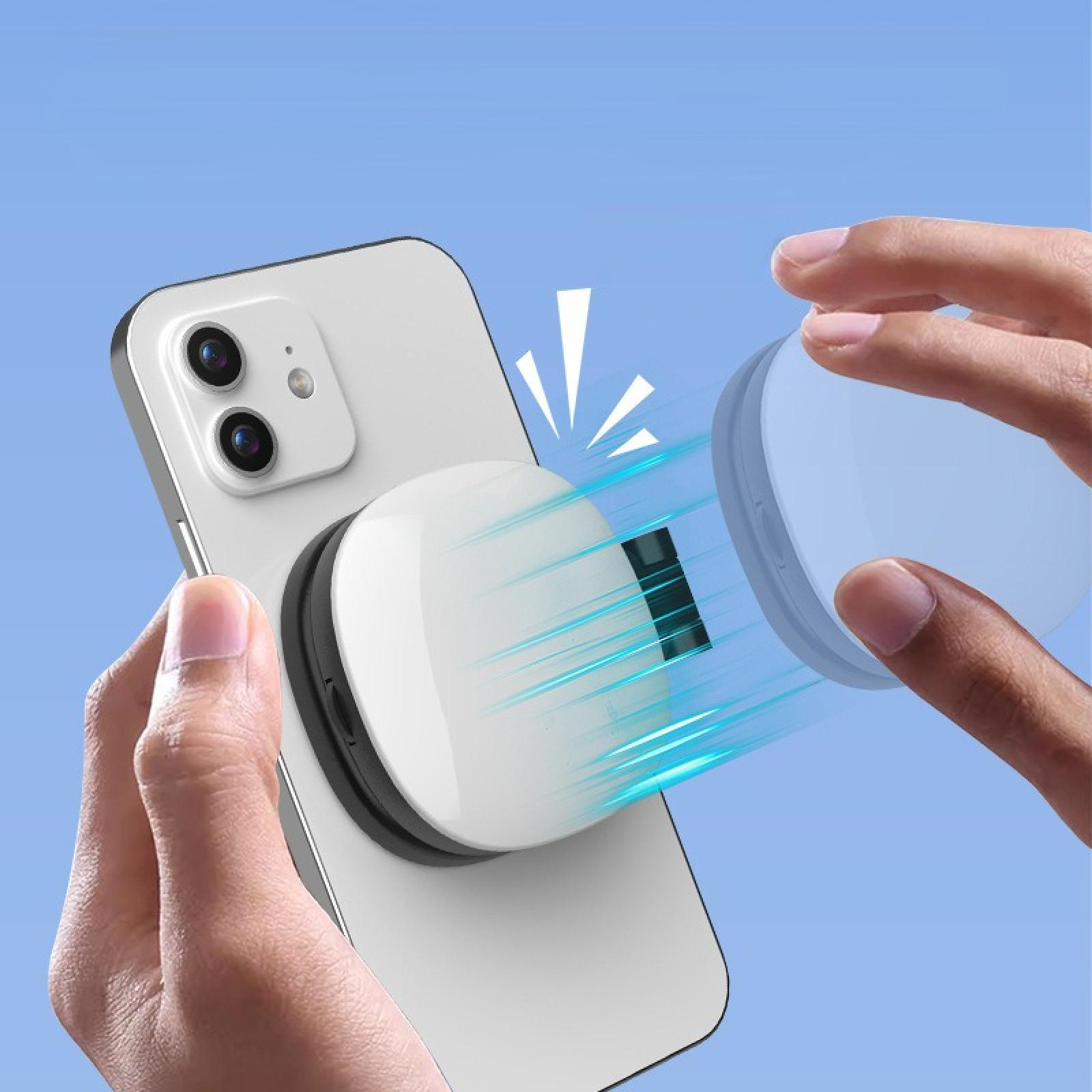 Eine Hand hält ein weißes Telefon mit einem weißen und schwarzen magnetischen Telefonhalter. Eine andere Hand hält den anderen Teil des Halters.