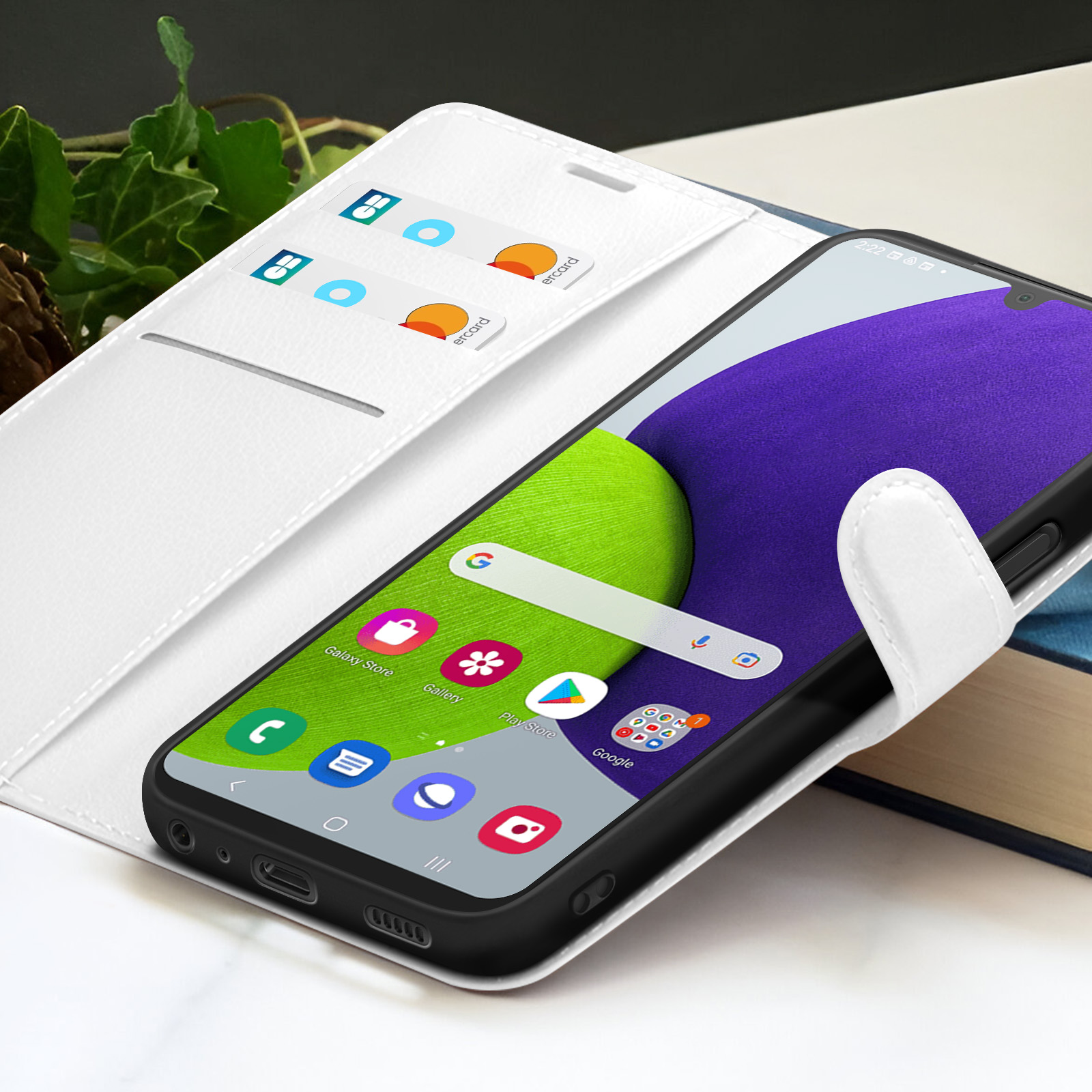 Un étui de téléphone blanc avec un téléphone. L'écran affiche des applications. Des cartes sont dans l'étui.