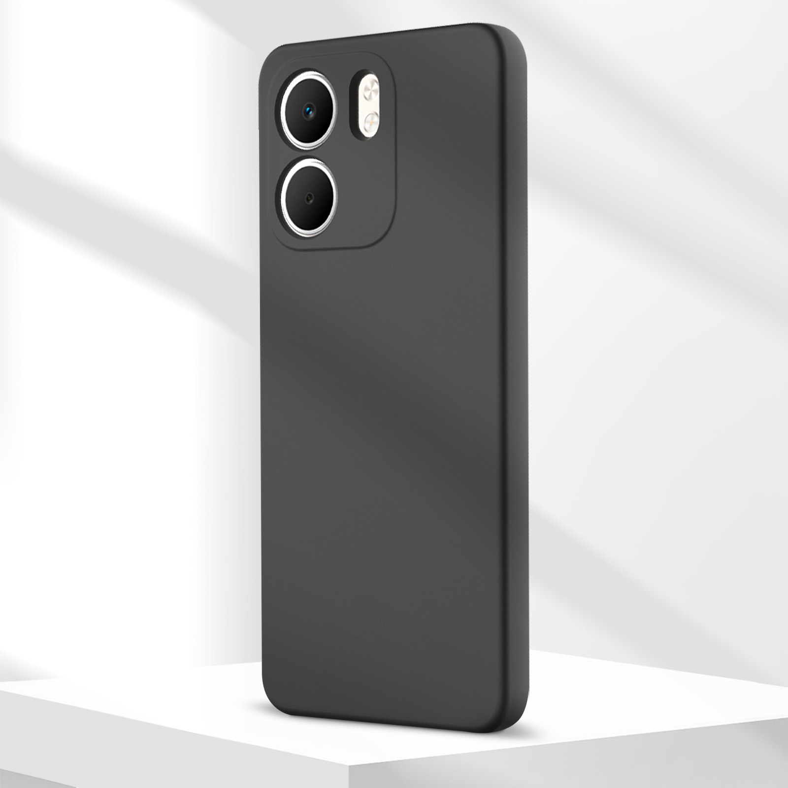 Una custodia nera per telefono con fori per fotocamera, su una superficie bianca e sfondo bianco con ombre.