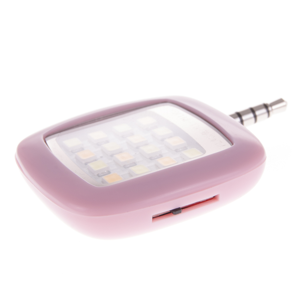 Un piccolo flash LED rettangolare rosa per telefono. Ha una griglia di luci e un jack audio argentato.