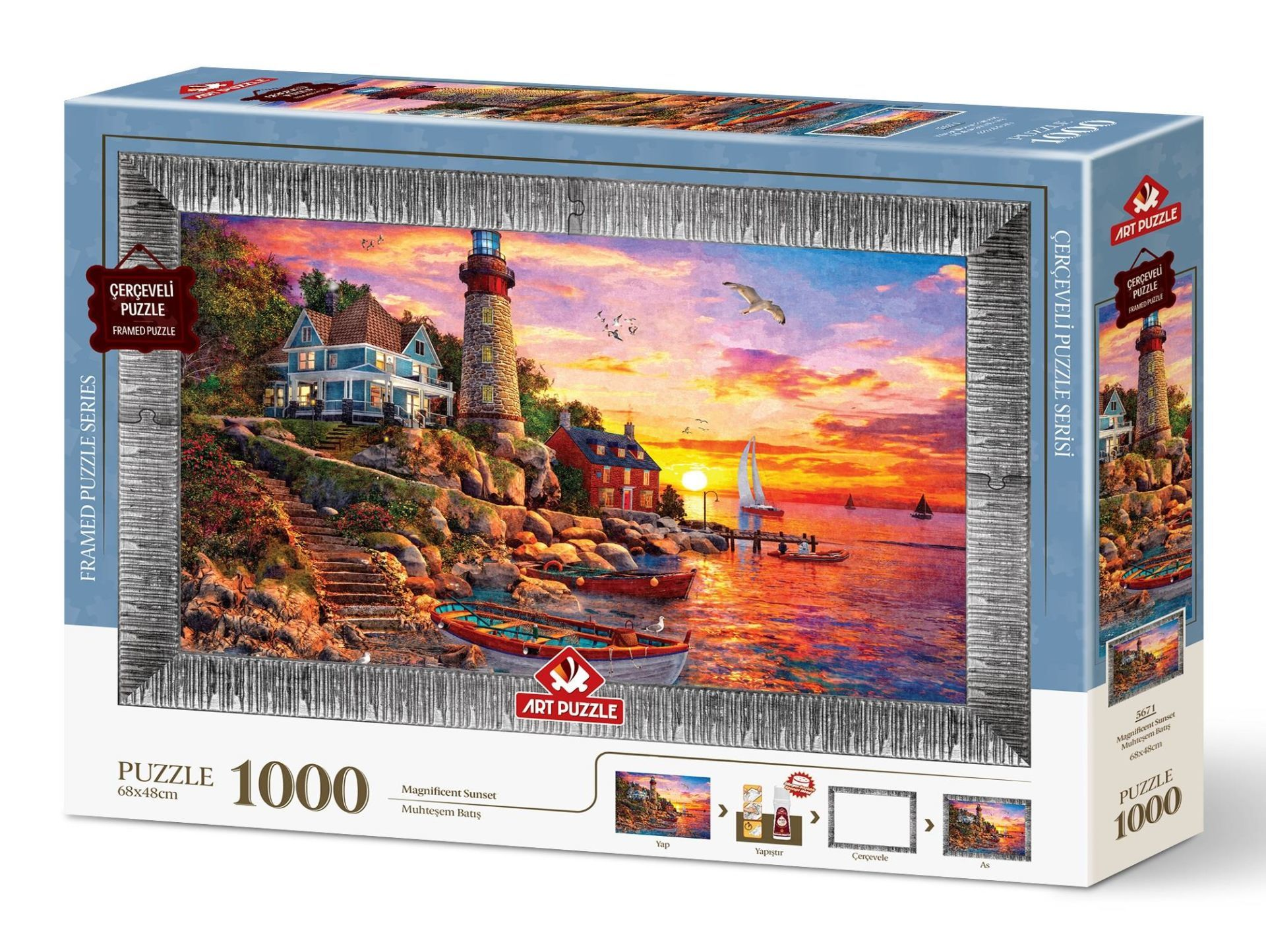 Gün batımı sahnesi içeren puzzle kutusu. Deniz feneri, evler, tekneler ve martılar kayalık bir kıyıda. Kutuda 'Framed Puzzle' yazıyor.