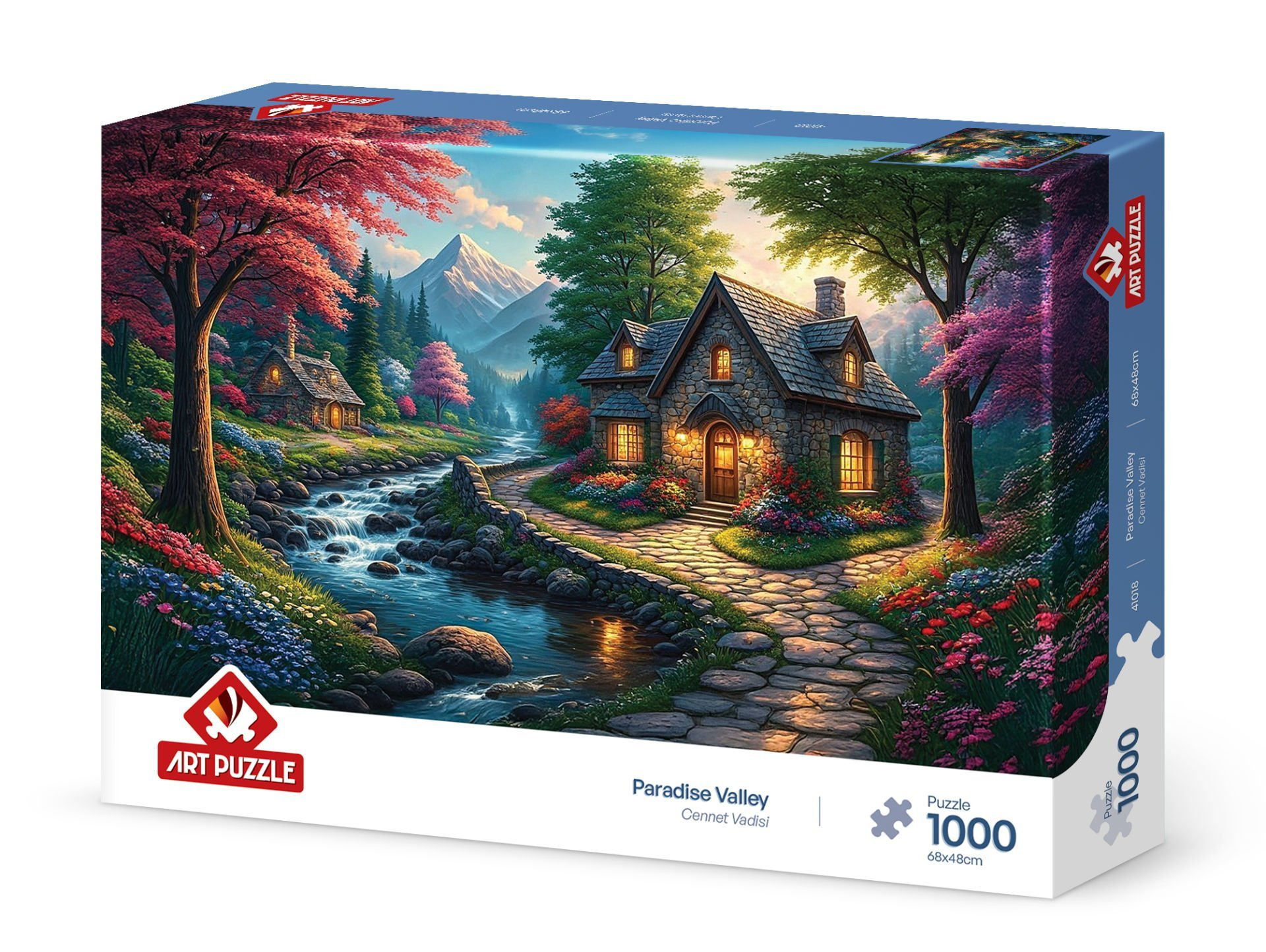 Yapboz kutusu, taş ev, nehir, dağlar ve renkli ağaçlarla dolu, manzaralı bir vadiyi gösteriyor. 'Paradise Valley', 'Art Puzzle' yazıyor.