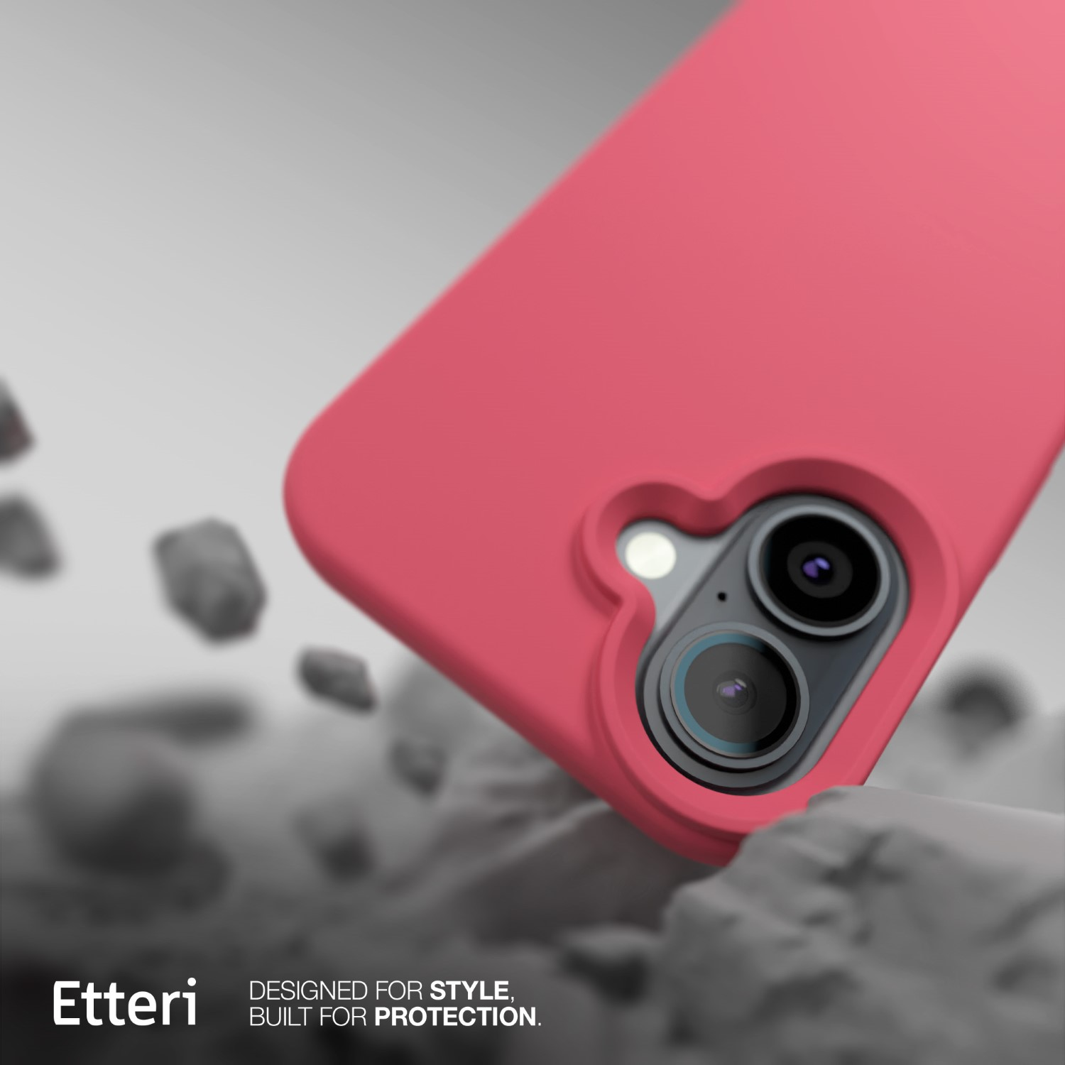 Una custodia rosa per telefono con doppie lenti della fotocamera è angolata, appoggiata su rocce grigie strutturate. Il marchio 'Etteri' è in basso a sinistra.