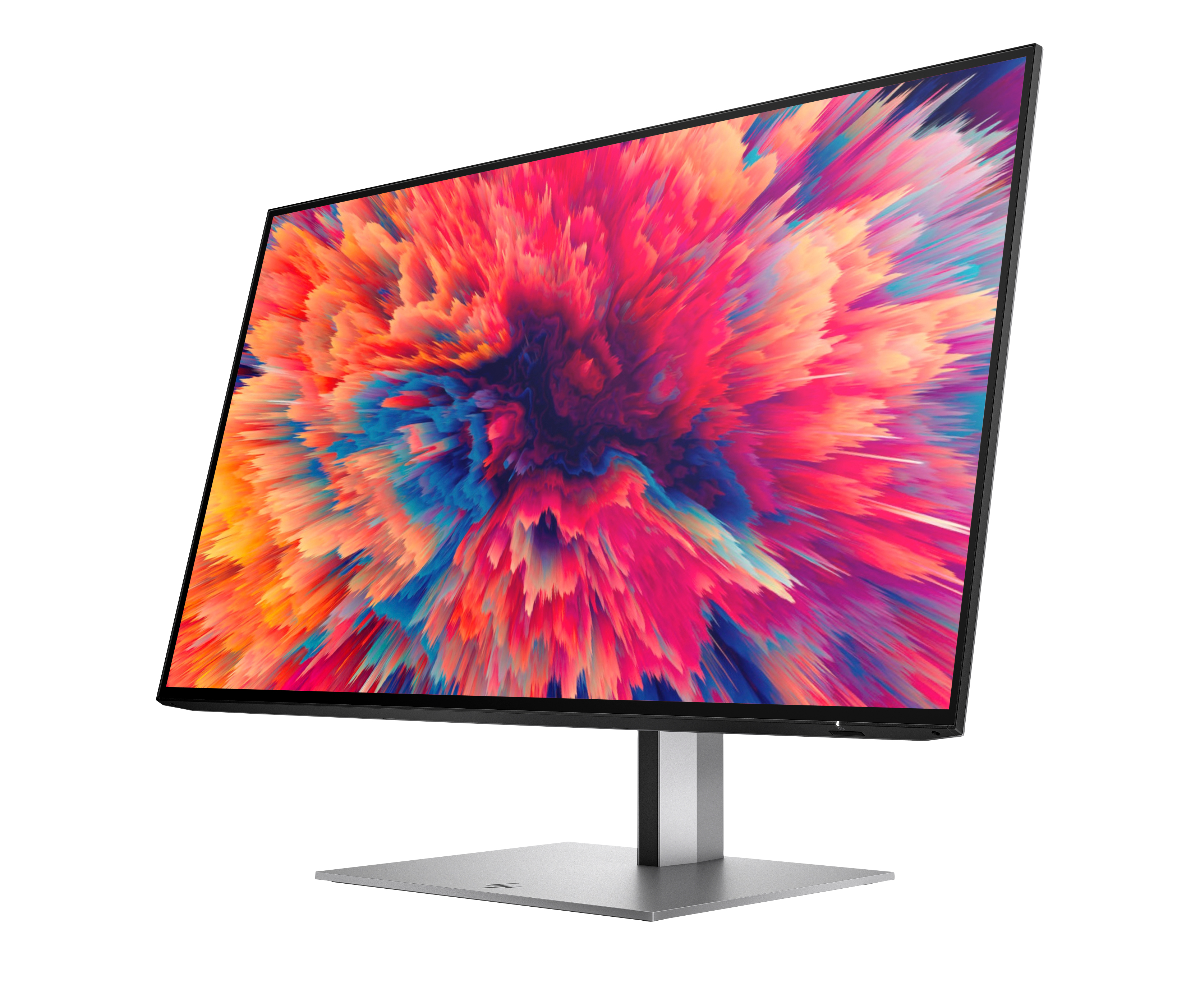 Un monitor de computadora que muestra una explosión abstracta y colorida. El monitor está sobre un soporte plateado sobre un fondo blanco.