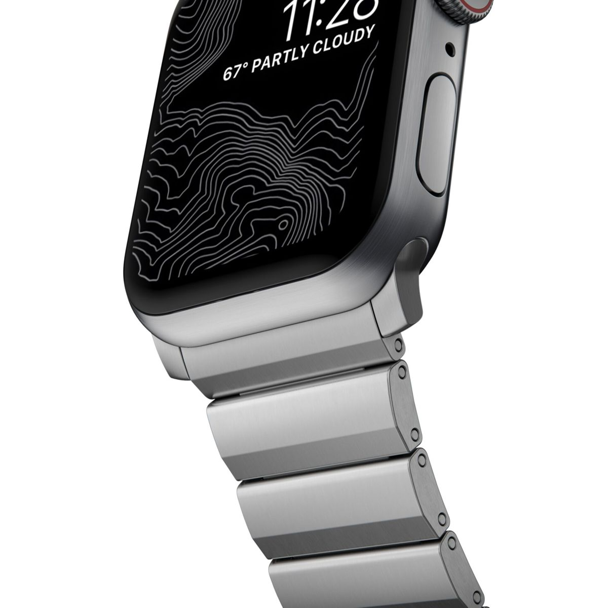 Apple Watch argentato con display a mappa topografica che mostra le 11:28 e 67 gradi parzialmente nuvoloso. Anche il cinturino è argentato.