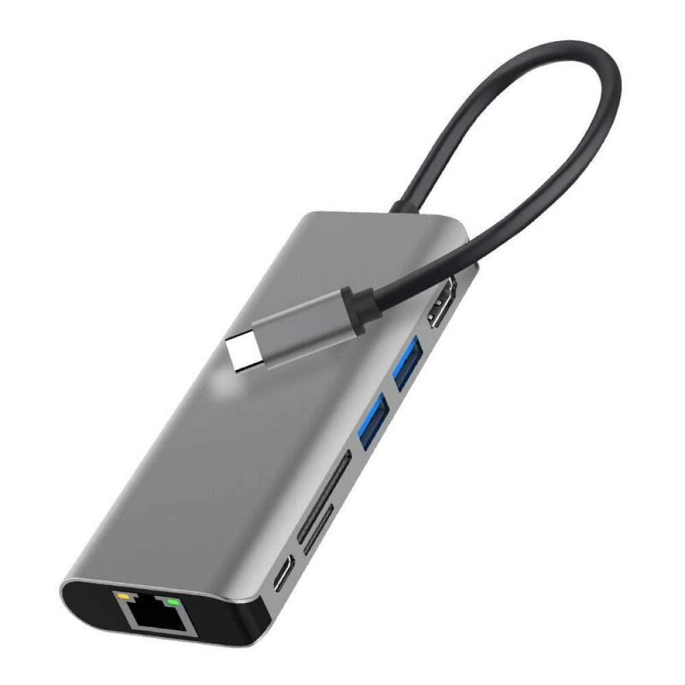 Ein silberner USB-Hub mit mehreren Anschlüssen, darunter USB, HDMI und Ethernet. Ein schwarzes Kabel verläuft vom Hub.