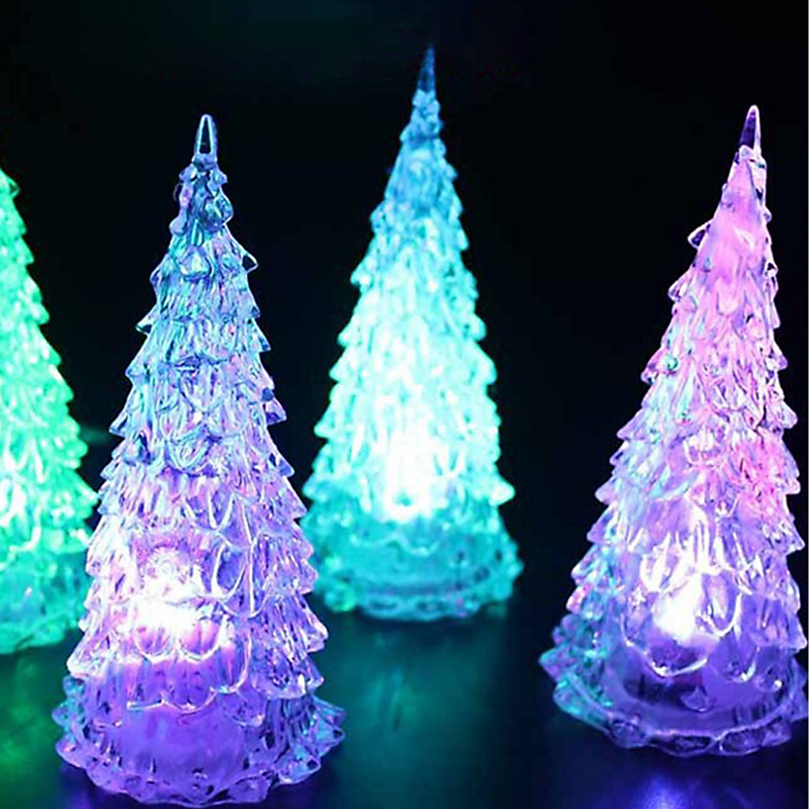 Vier leuchtende, farbenfrohe Weihnachtsbaumdekorationen. Sie sind lila, blau und grün, mit schwarzem Hintergrund.