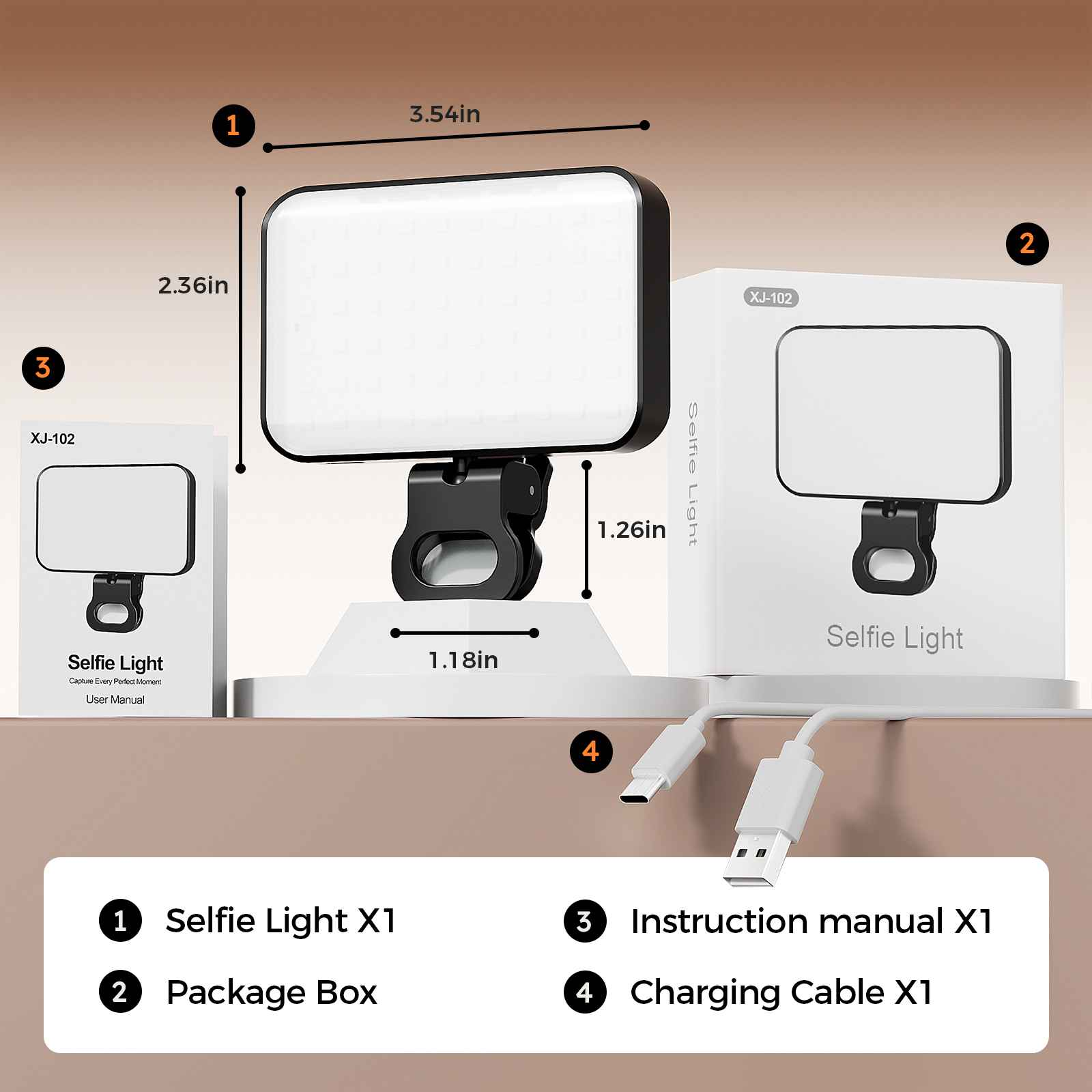 Ein Selfie-Licht, eine Box, eine Anleitung und ein Ladekabel liegen auf einer Oberfläche. Das Licht ist rechteckig, mit einem schwarzen Clip.