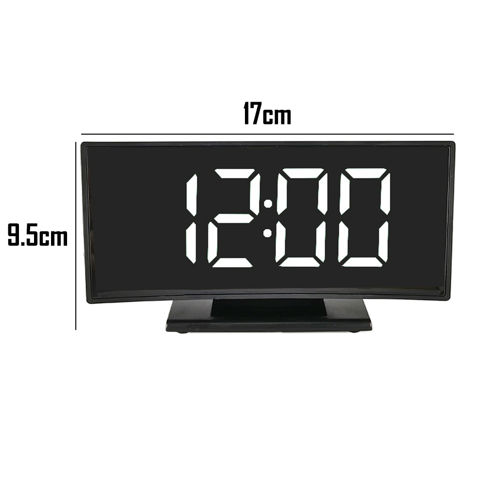 Schwarze Digitaluhr, die 12:00 anzeigt. Sie ist 17 cm breit und 9,5 cm hoch. Die Uhr hat einen schwarzen Sockel und einen weißen Hintergrund.