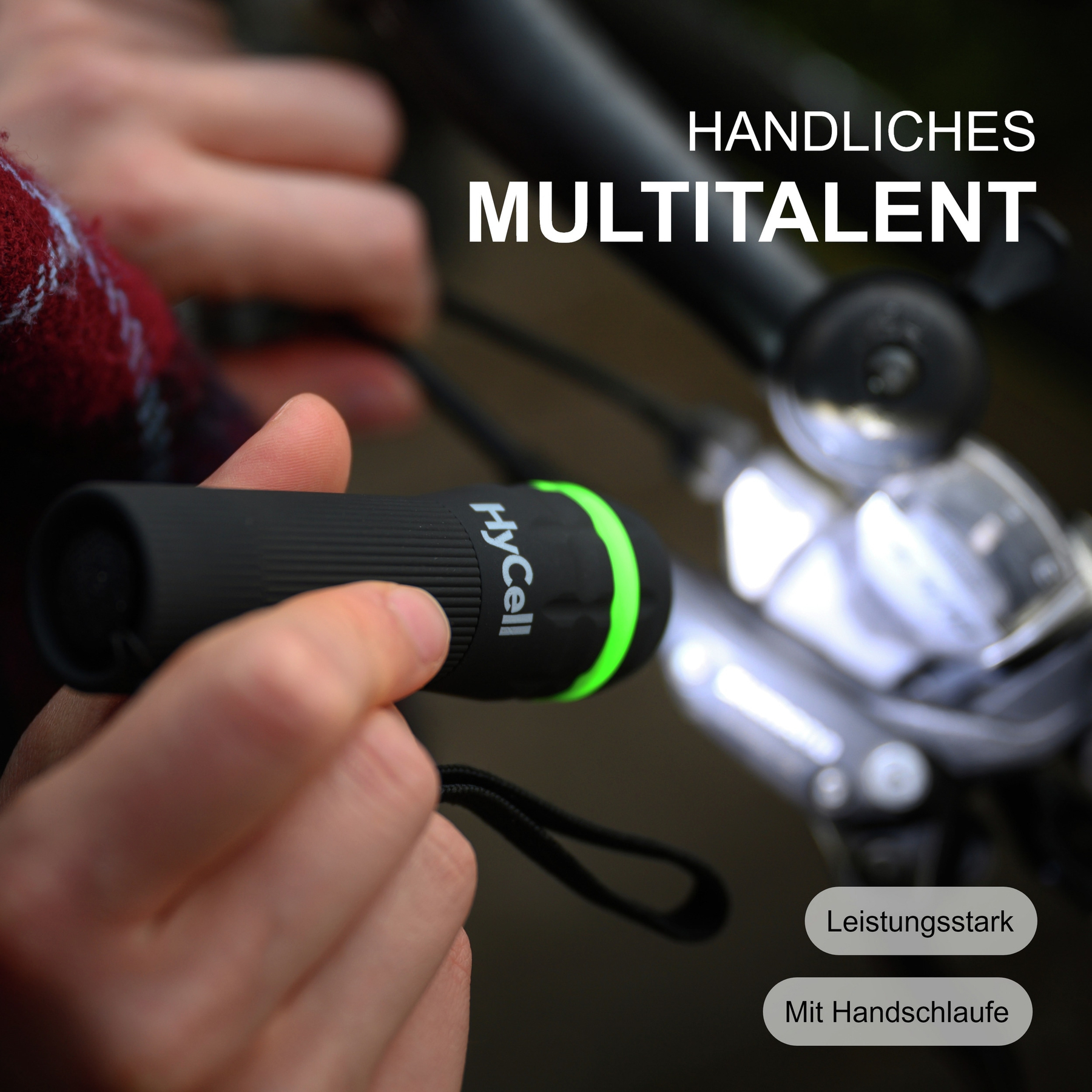 Une personne tient une lampe de poche noire avec un anneau vert. Le texte 'HANDLICHES MULTITALENT' est au-dessus. Le texte additionnel dit 'Leistungsstark'.