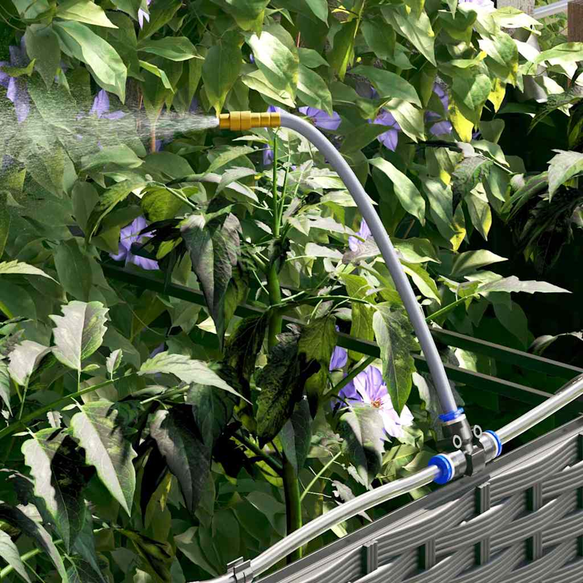 Un tubo da giardino spruzza acqua su piante verdi con fiori viola. Il tubo è grigio e ha raccordi blu e gialli.