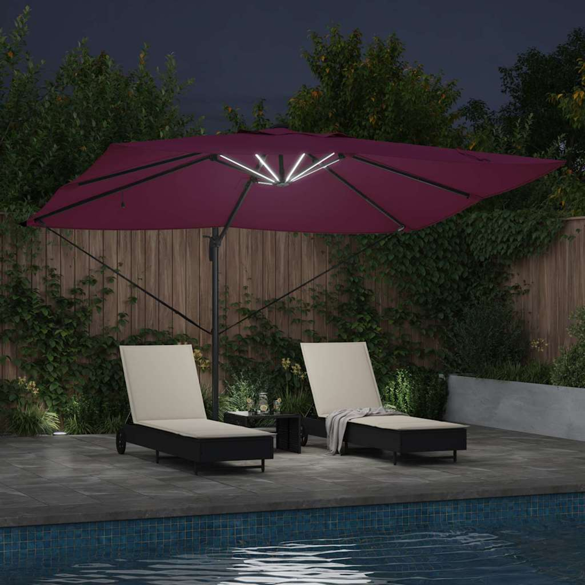 Nachtszenen mit Pool, Liegestühlen, einem weinroten Sonnenschirm und einem kleinen Tisch, alle durch Lichter beleuchtet. Grünes Laub im Hintergrund.