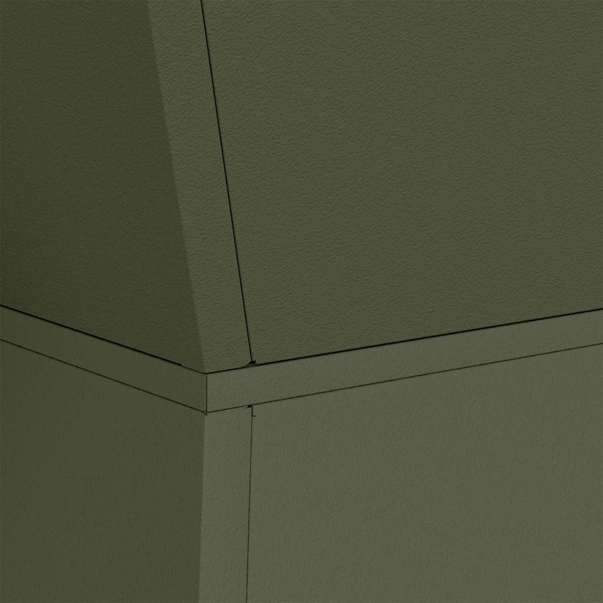Primo piano di superfici verde oliva strutturate che si incontrano ad angoli. Linee nere definiscono bordi e cuciture, suggerendo una struttura.