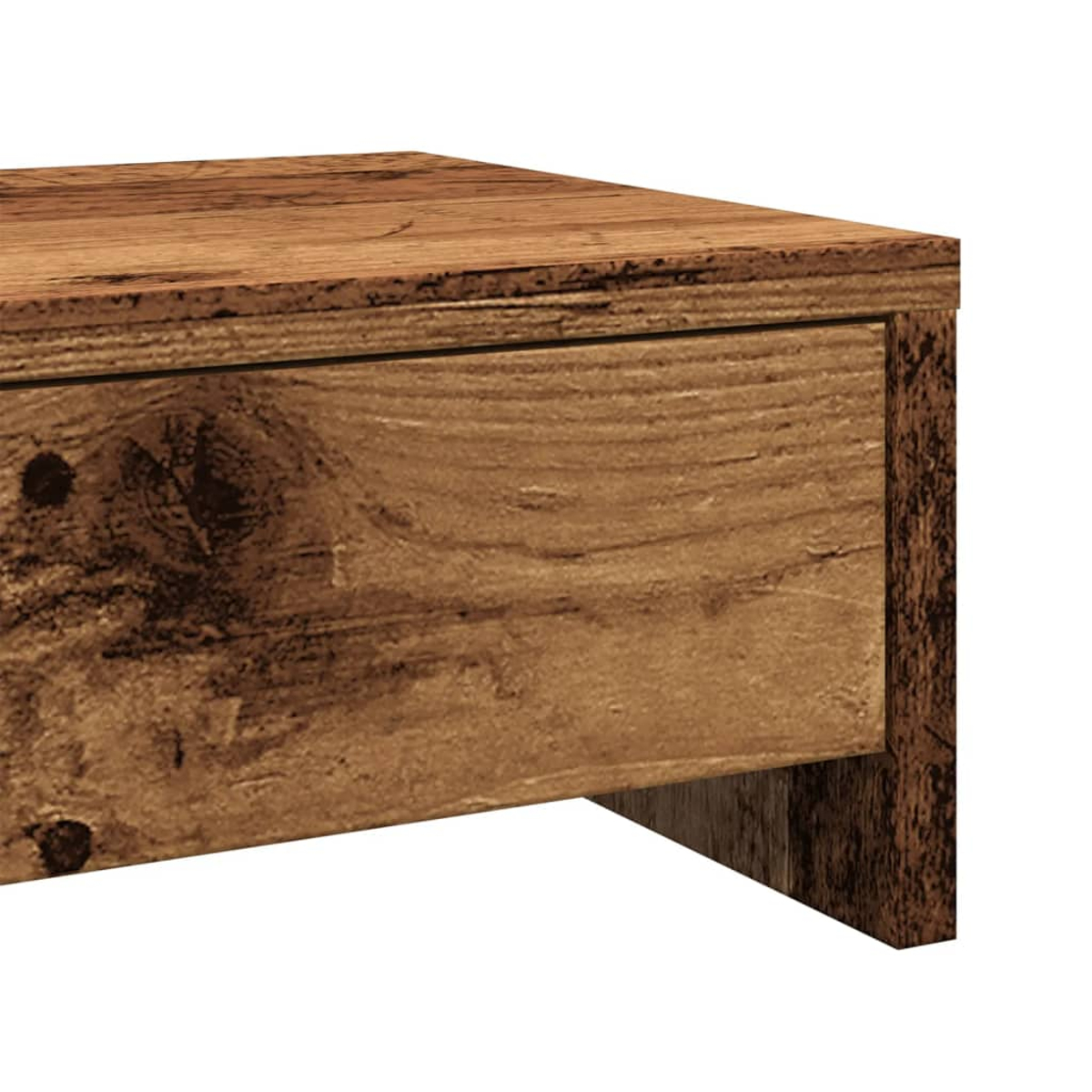 Nahaufnahme eines Holztisches oder einer Schublade. Das Holz hat eine braune, strukturierte Oberfläche mit sichtbaren Maserungsmustern. Der Hintergrund ist weiß.