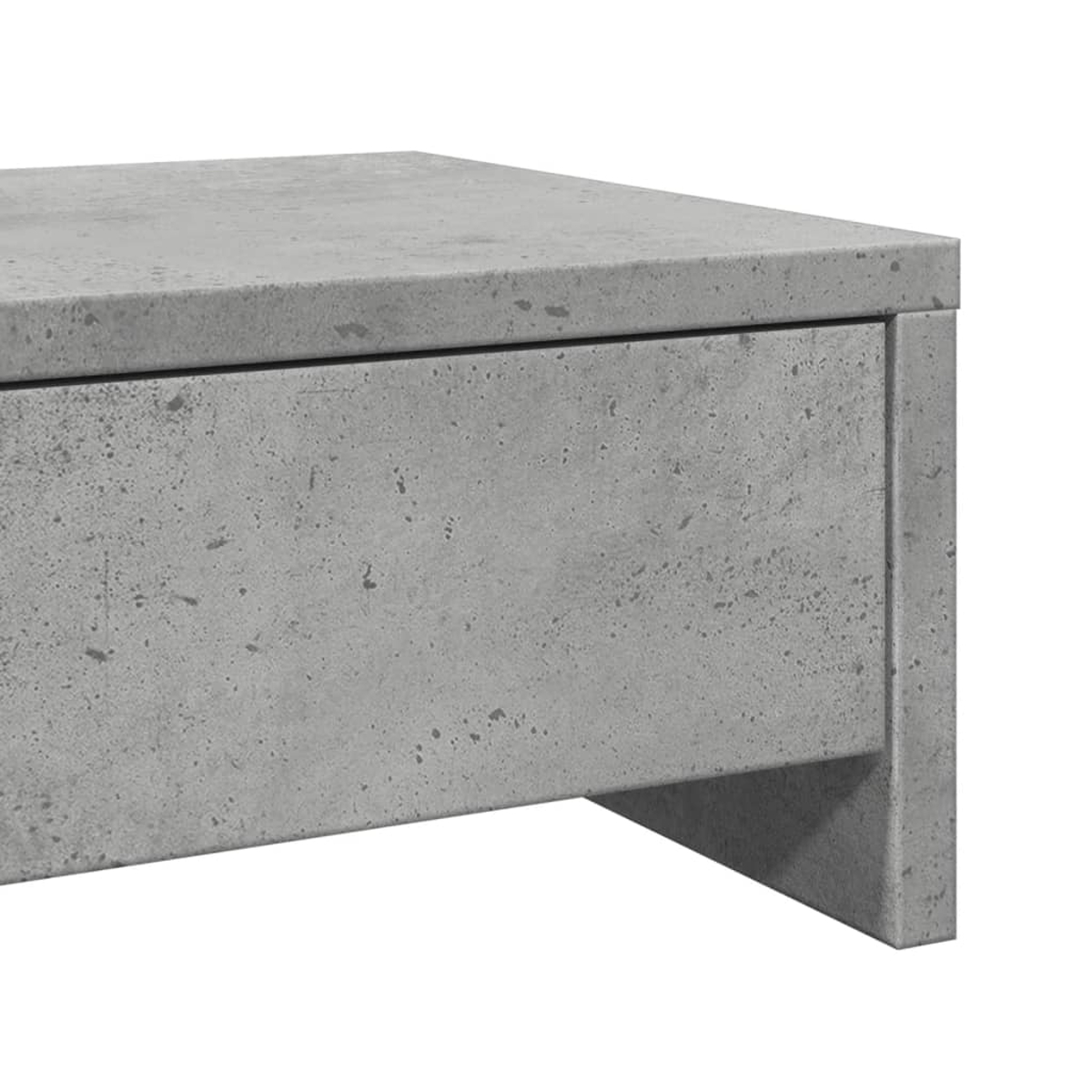 Nahaufnahme einer grauen Betonschublade mit sichtbarer Oberseite. Die Schublade hat eine strukturierte Oberfläche mit kleinen Punkten.