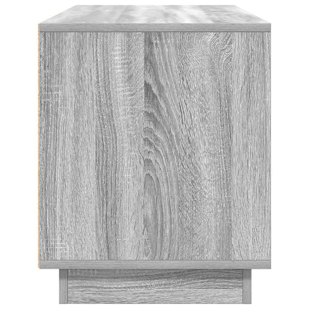 Ein grauer Holzschrank. Er hat eine rechteckige Form mit sichtbarer Holzmaserung. Der Schrank hat einen Sockel und eine Oberseite.