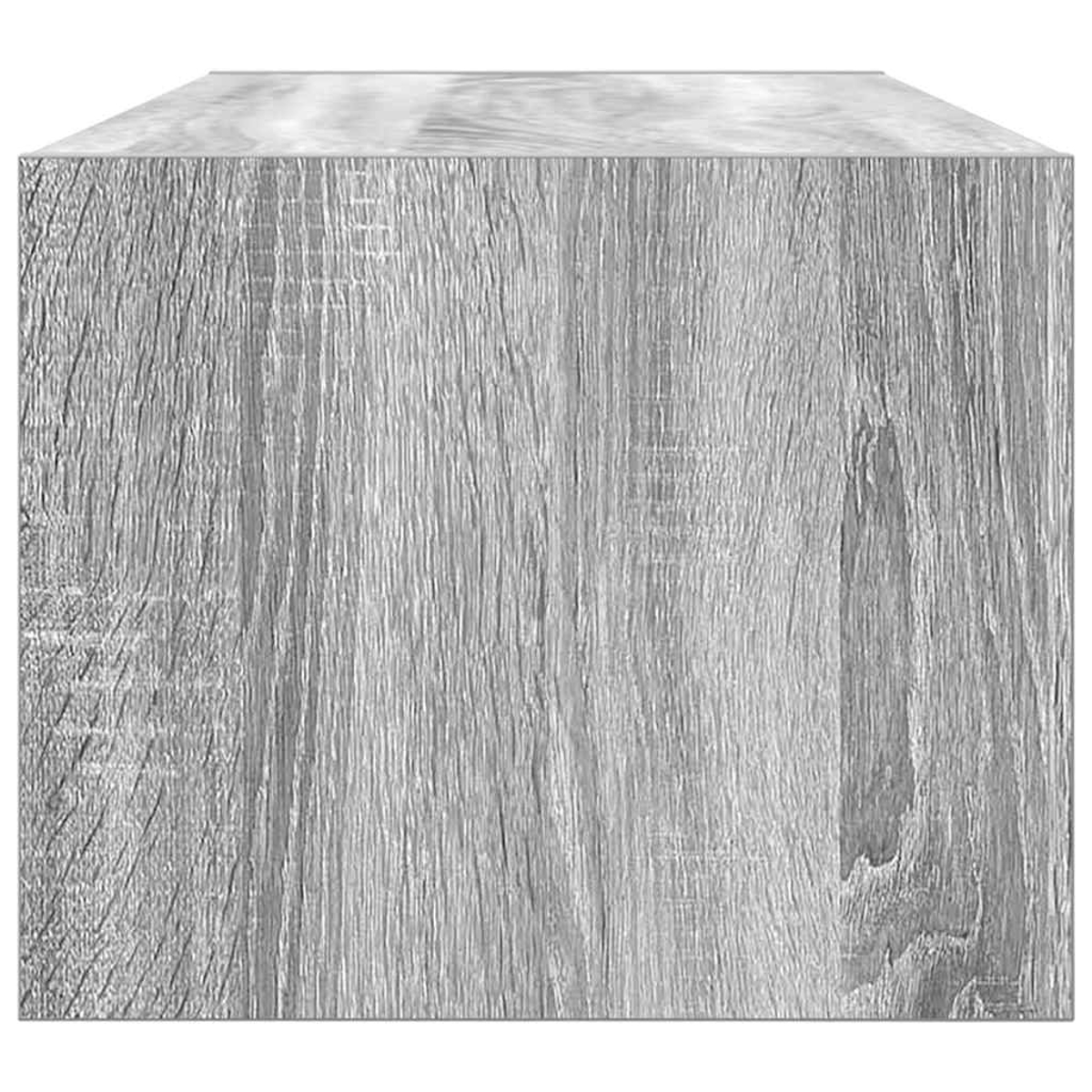 Nahaufnahme eines grauen Holzblocks. Die Holzmaserung ist sichtbar und zeigt vertikale Linien und einige Knoten. Der Block ist rechteckig.