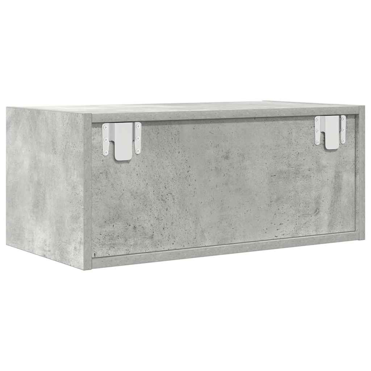 Eine graue Betonbox mit zwei weißen Metallscharnieren. Die Box hat eine raue Textur und ist rechteckig.