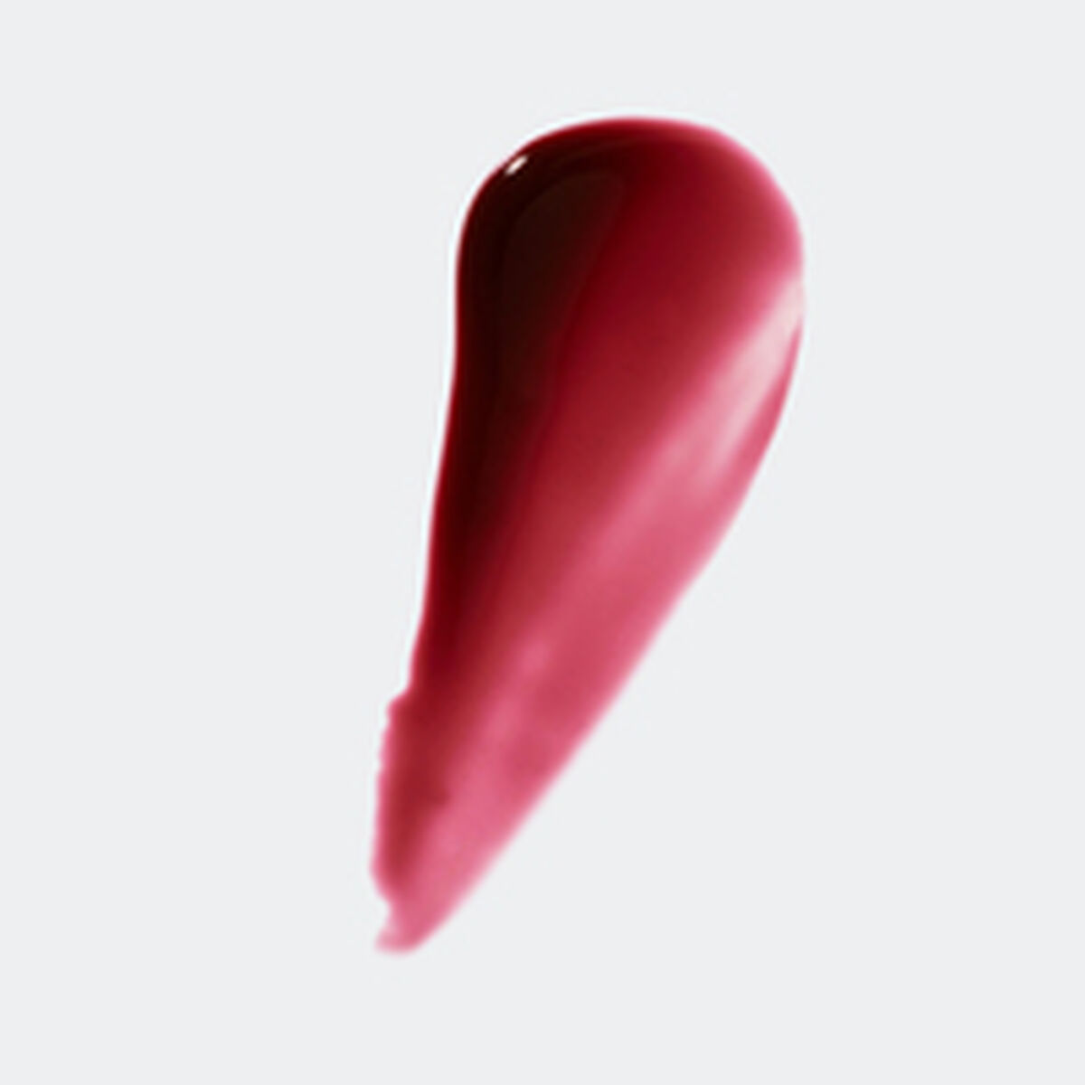 Ein Tropfen dunkelroter Flüssigkeit, möglicherweise Lipgloss, vor weißem Hintergrund. Der Farbverlauf ist sichtbar.