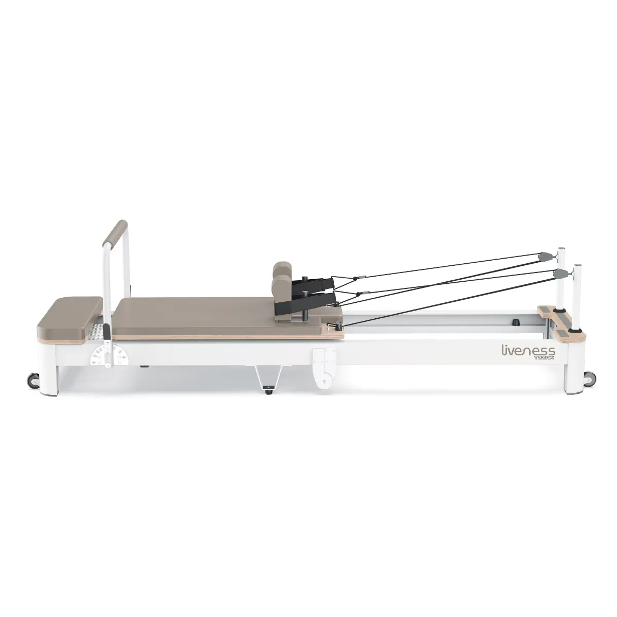 A Pilates reformer machine on a white background. It has a grey bed, black straps, and wooden accents. The brand name is 'liveness'.