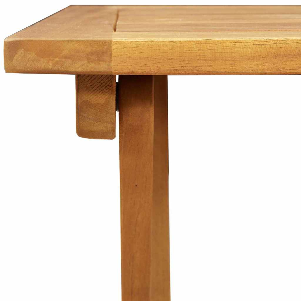 Nahaufnahme einer Holztischecke. Tischbein und Stütze sind sichtbar. Das Holz ist hellbraun.
