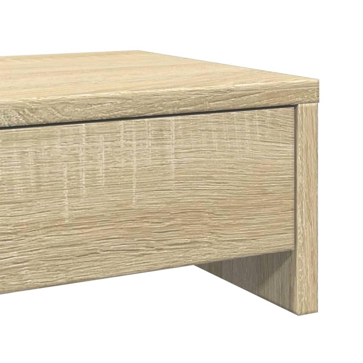 Nahaufnahme eines hellen Holztisches. Der Tisch hat eine Schublade und ein Bein. Das Holz hat sichtbare Maserung.