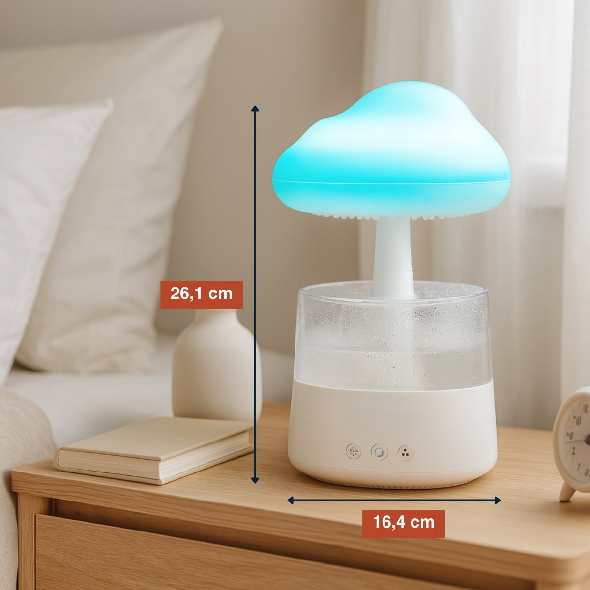 A mushroom-shaped humidifier on a nightstand. It has a blue cloud-like top, a white base, and is next to a book and a clock.