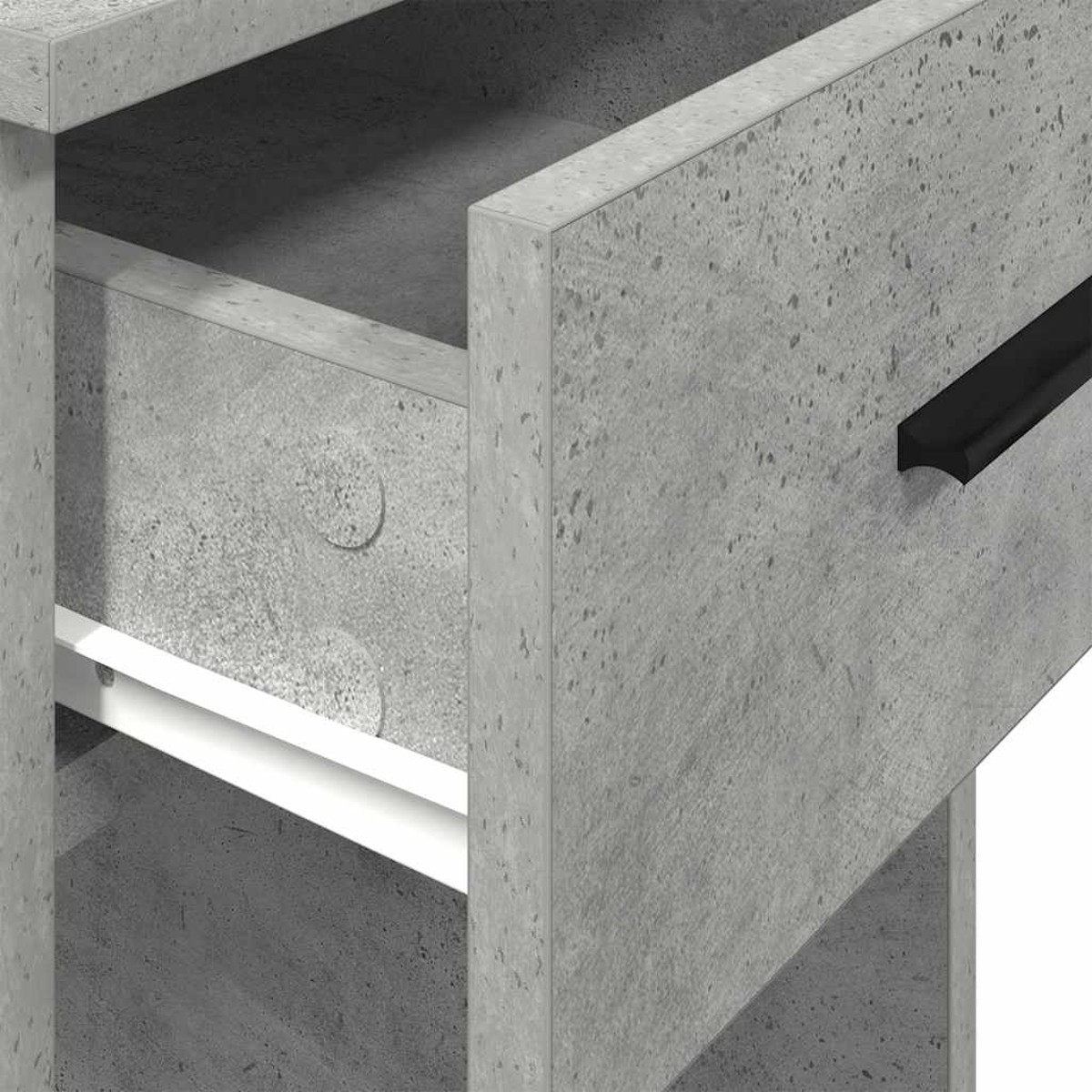 Nahaufnahme eines grauen Schranks mit offener Schublade. Die Schublade hat einen schwarzen Griff, der Schrank ist aus Beton.