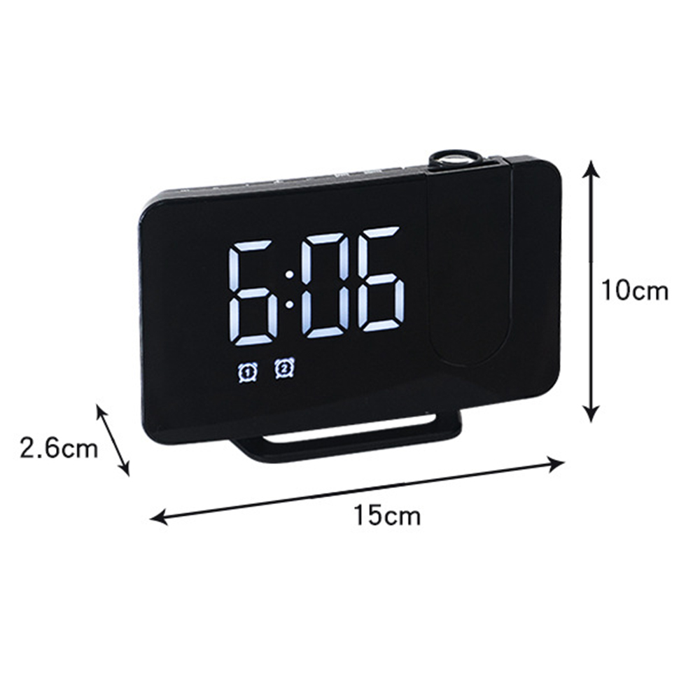 Ein schwarzer digitaler Wecker zeigt 6:06 an. Abmessungen sind angegeben: 15 cm lang, 10 cm hoch und 2,6 cm dick.