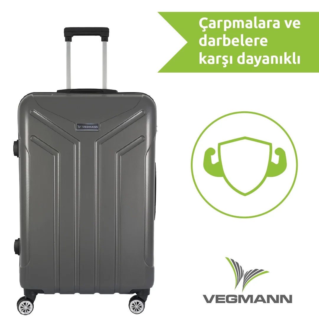 Geri çekilebilir saplı, tekerlekli ve logolu gri bir VEGMANN bavul. Yeşil metin ve kalkan simgesi dayanıklılığı gösterir.