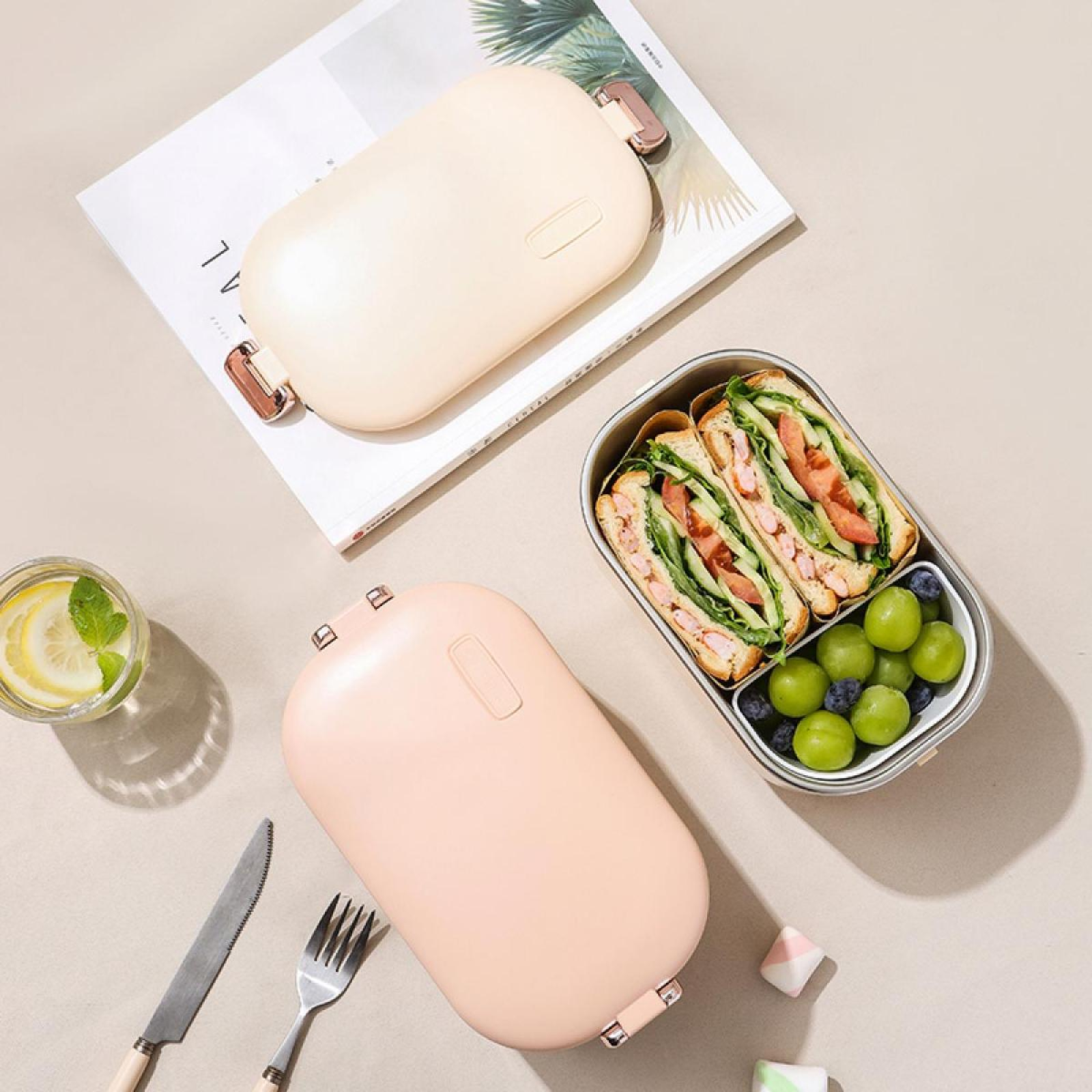 Mittagessen-Arrangement: Sandwiches, Trauben, Blaubeeren und zwei Lunchboxen. Auch ein Glas Wasser, ein Messer und eine Gabel.