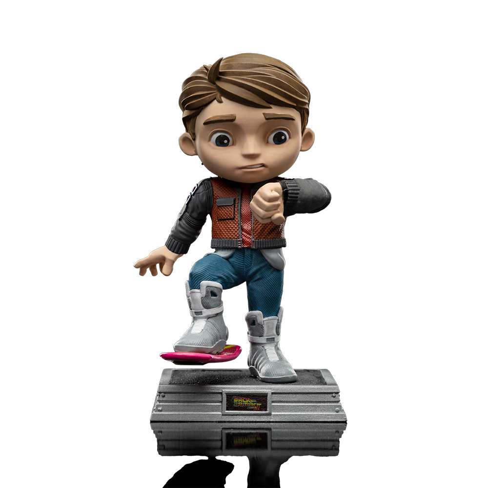 Statuina di Marty McFly su un hoverboard. Indossa un gilet rosso, jeans blu e stivali bianchi. La base dice 'Ritorno al futuro'.