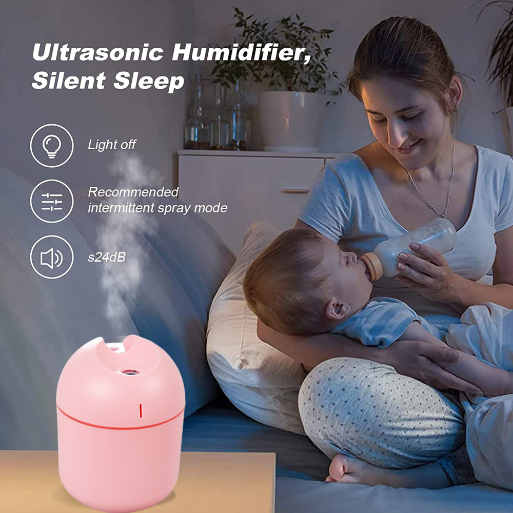 Eine Frau füttert ein Baby mit einer Flasche. Ein rosa Luftbefeuchter steht auf einem Nachttisch. Text erwähnt ruhigen Schlaf und intermittierenden Sprühstoß.