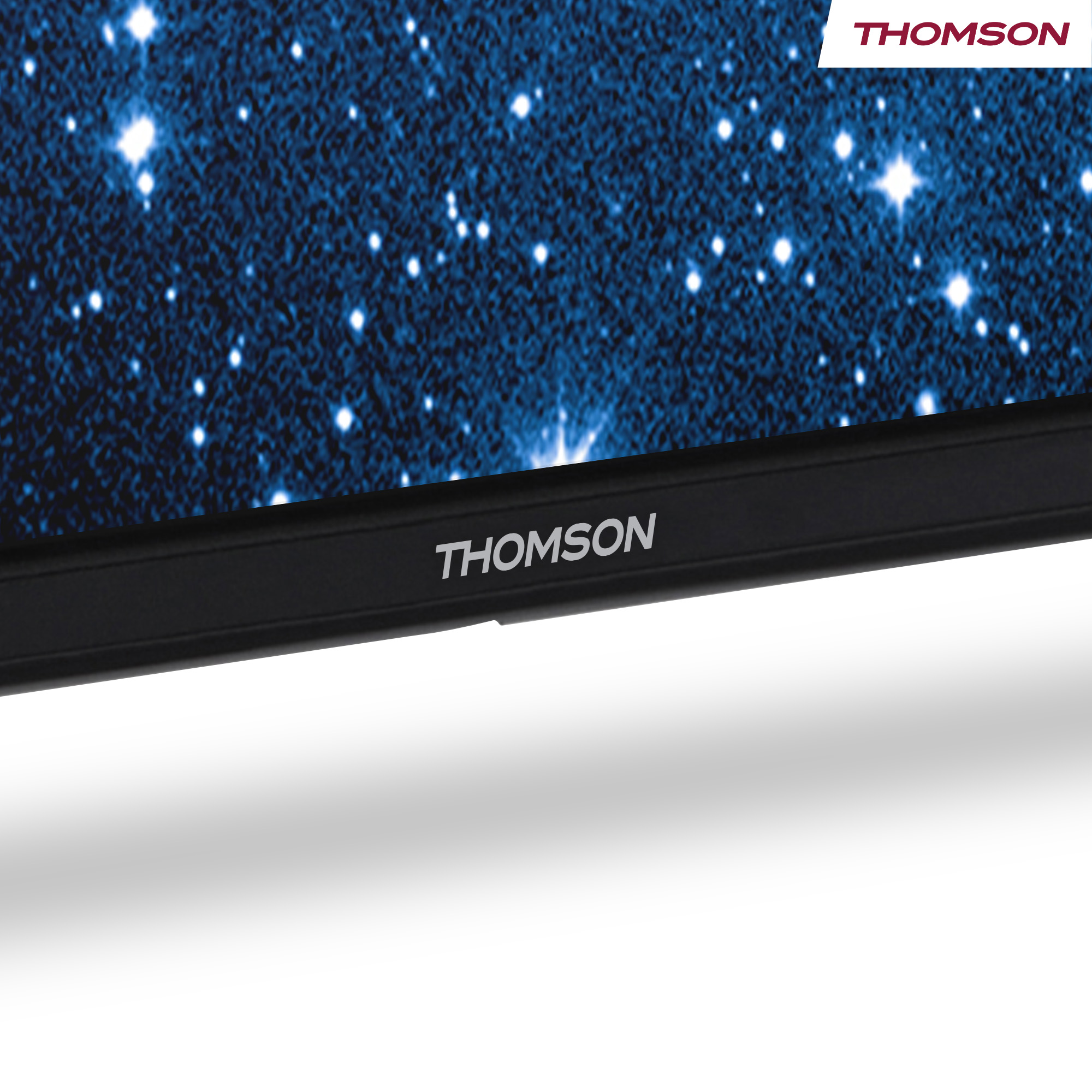 A TV screen displays a starry night scene. The bottom of the TV has the brand name 'THOMSON' in white letters.