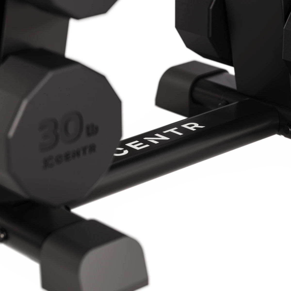 Close-up of black dumbbells on a rack. One dumbbell shows 30lb, the brand CENTR is visible. White background.