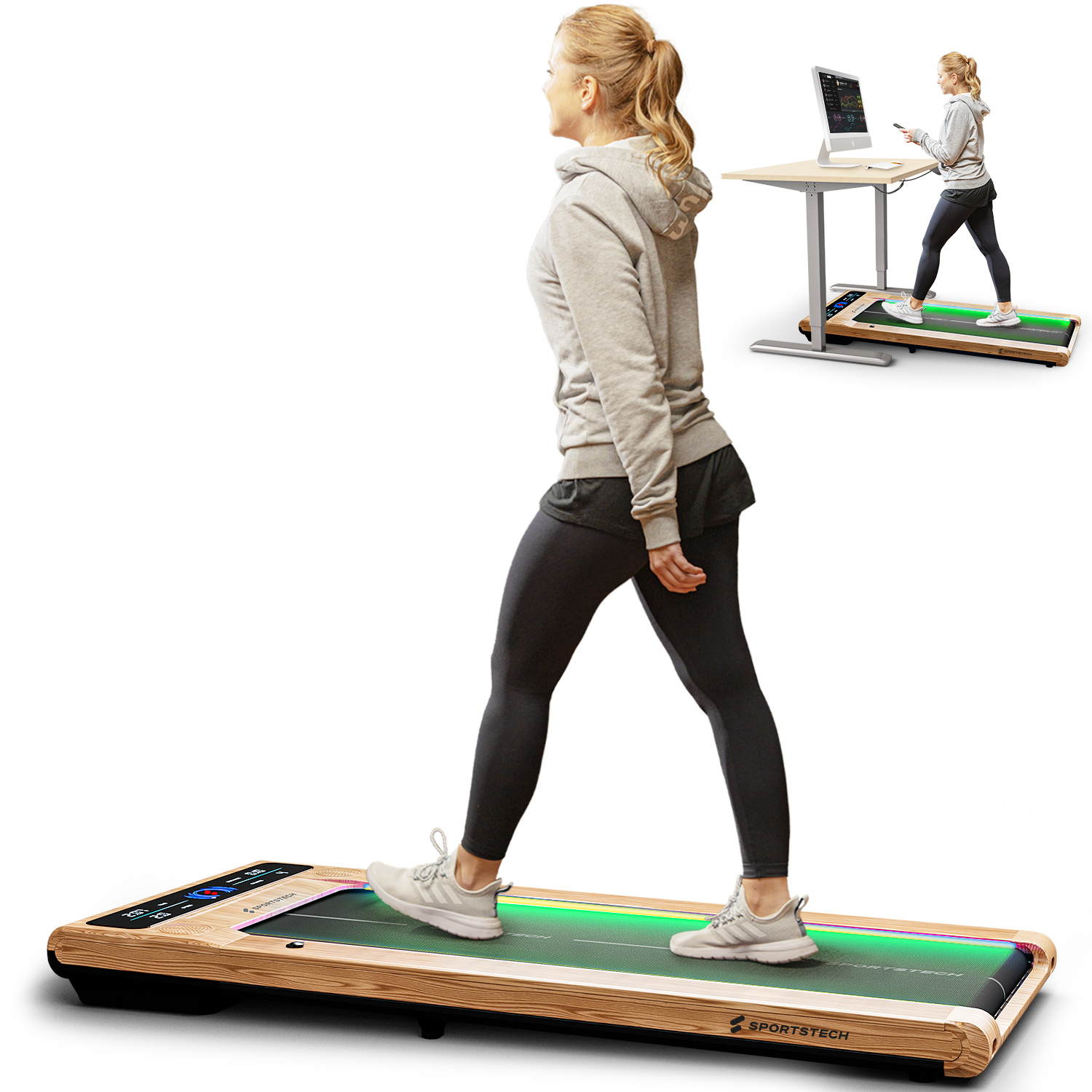 Eine Frau geht auf einem Laufband. Sie trägt einen grauen Kapuzenpullover und schwarze Leggings. Ein Schreibtisch mit Monitor im Hintergrund.