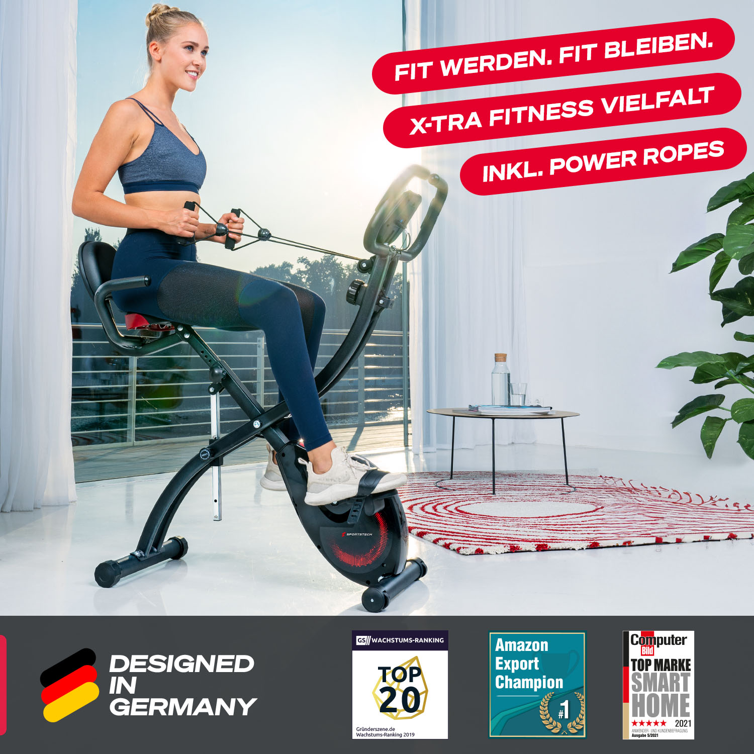 Eine Frau trainiert an einem Fitnessgerät. Die Maschine ist schwarz und rot. Oben steht 'FIT WERDEN. FIT BLEIBEN.' und 'X-TRA FITNESS VIELFALT'.