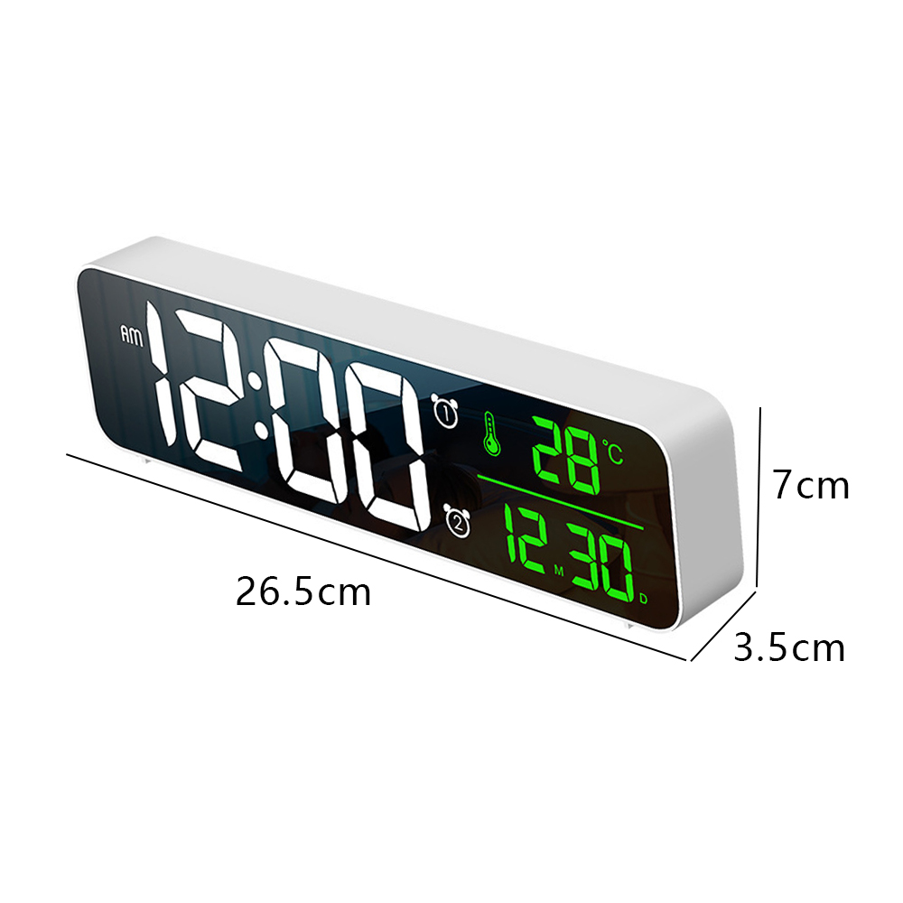 Digitaluhr zeigt 12:00 Uhr morgens, 28°C und 12:30 Uhr. Sie ist weiß mit schwarzem Display, Abmessungen sind angegeben.