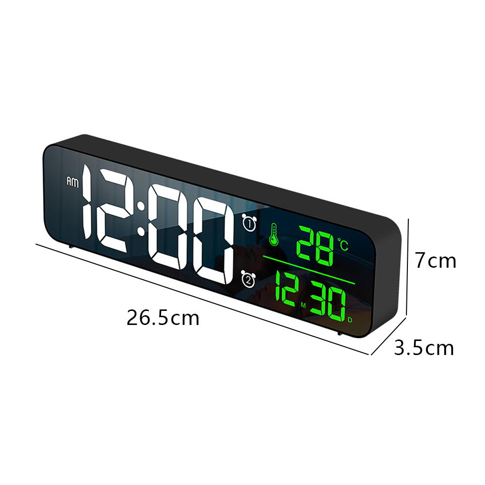 Eine schwarze Digitaluhr zeigt 12:00 AM, Temperatur 28°C und Datum 12.30 an. Abmessungen: 26,5 cm x 7 cm x 3,5 cm.