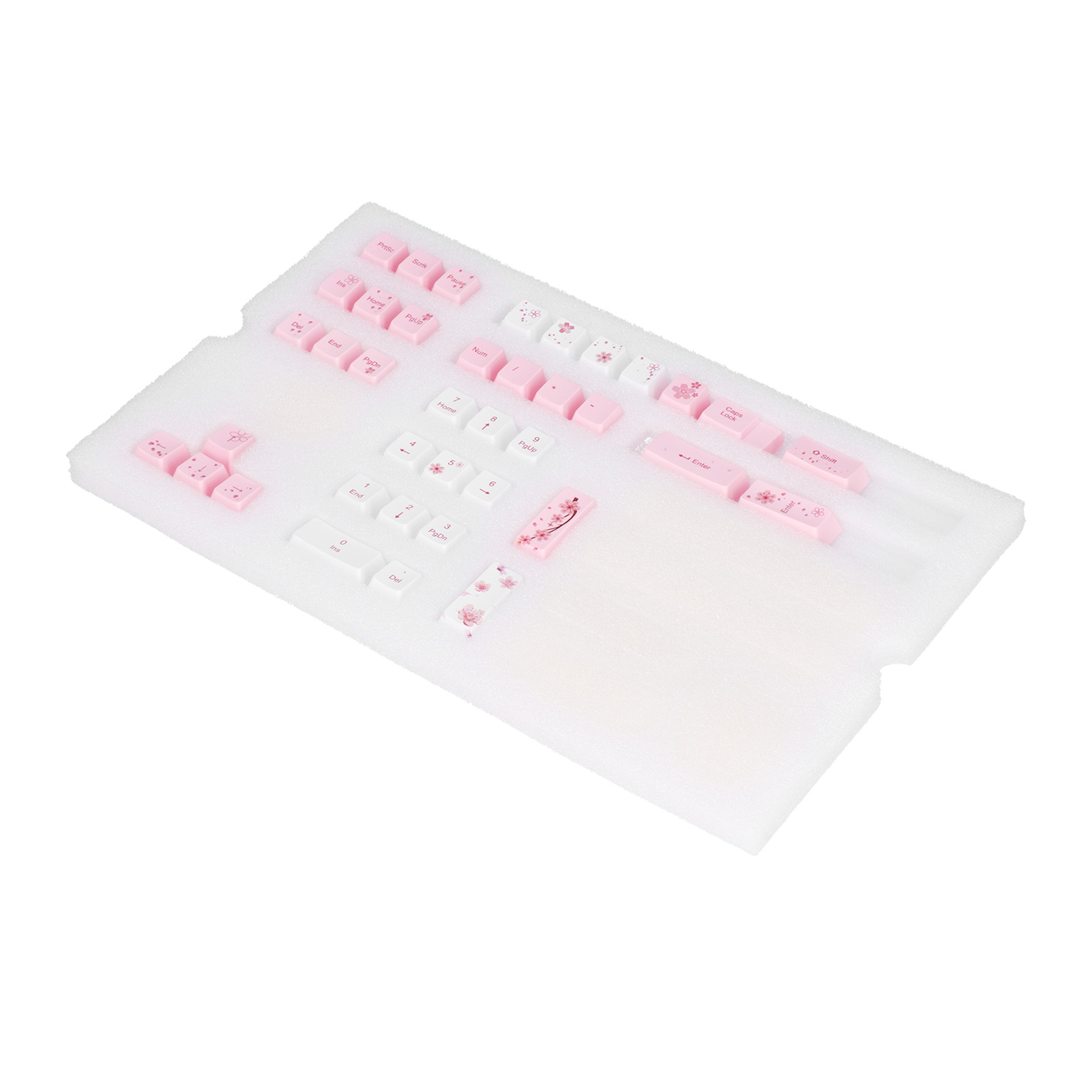 Tastaturtasten, rosa und weiß, mit gedruckten Zeichen und Blumendesigns, auf einer weißen Schaumstoffoberfläche.