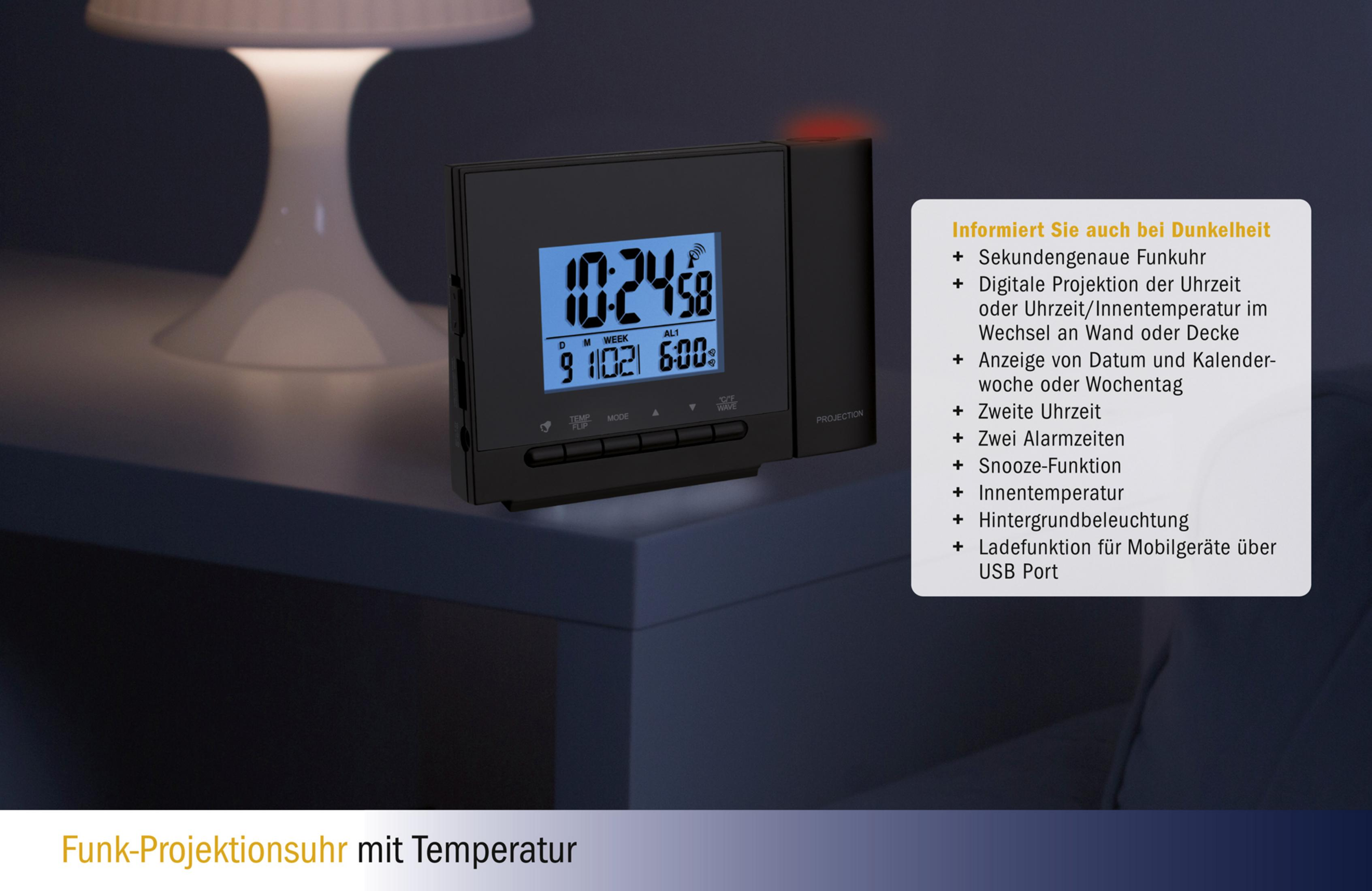Schwarze digitale Projektionsuhr mit Zeitanzeige. Merkmale sind Datum, Alarme und Temperatur. Auf weißer Oberfläche neben Lampe.