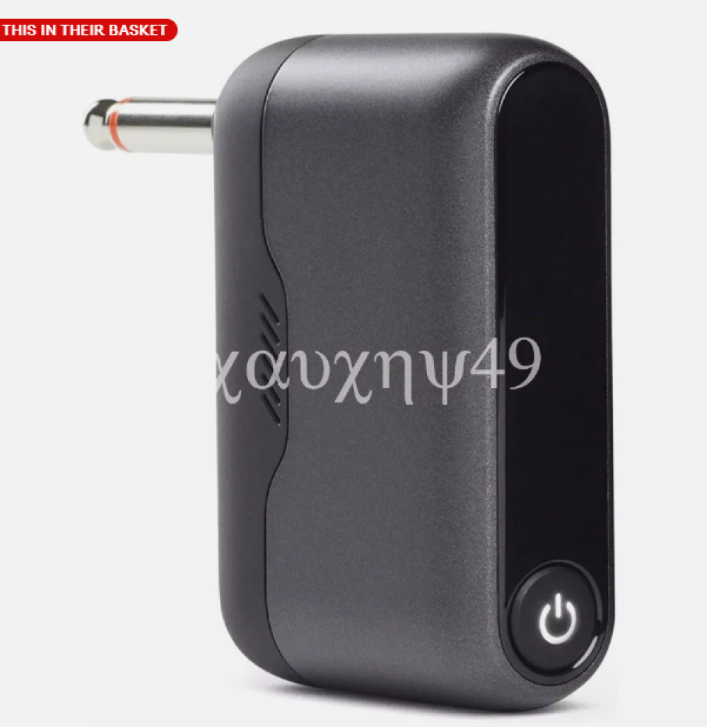 Ein schwarzes Audiogerät mit silbernem Stecker und Ein/Aus-Knopf. Das Gerät hat eine griechische Textüberlagerung.