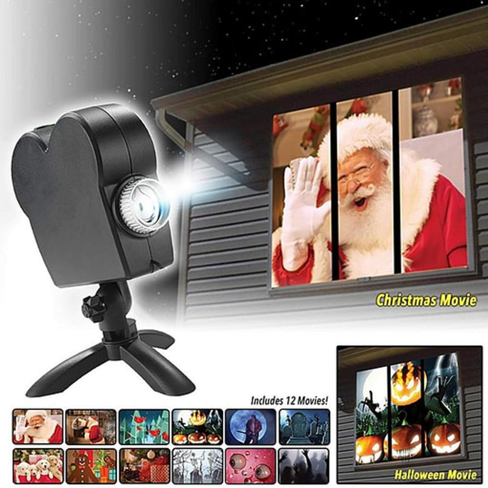Ein Projektor zeigt Santa in einem Fenster, mit Optionen für Halloween-Szenen. Enthält 12 Filme. Der Projektor ist schwarz.